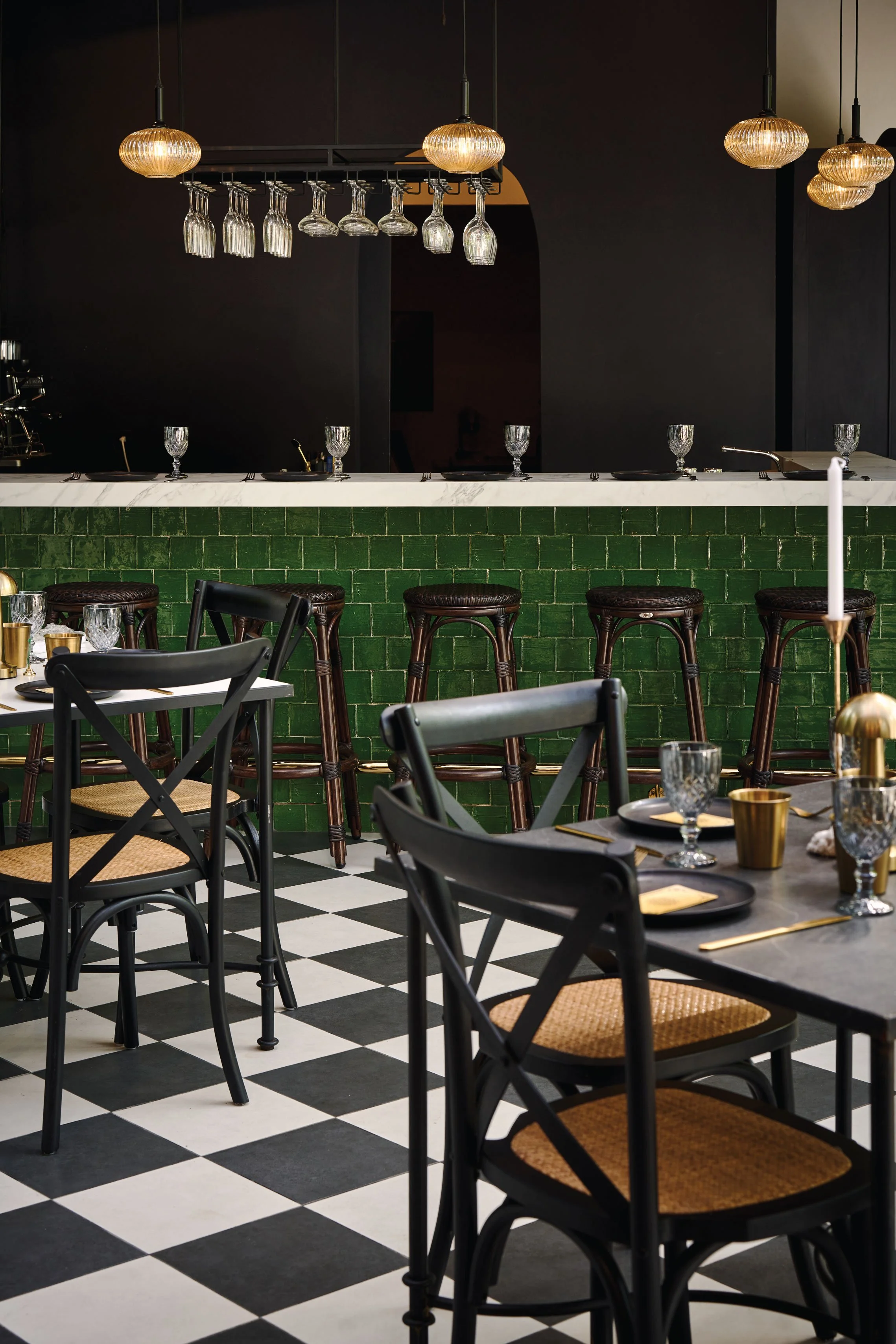 Evening dining tables with brass lamps, goblets and candles in the garden, Casa de Malka