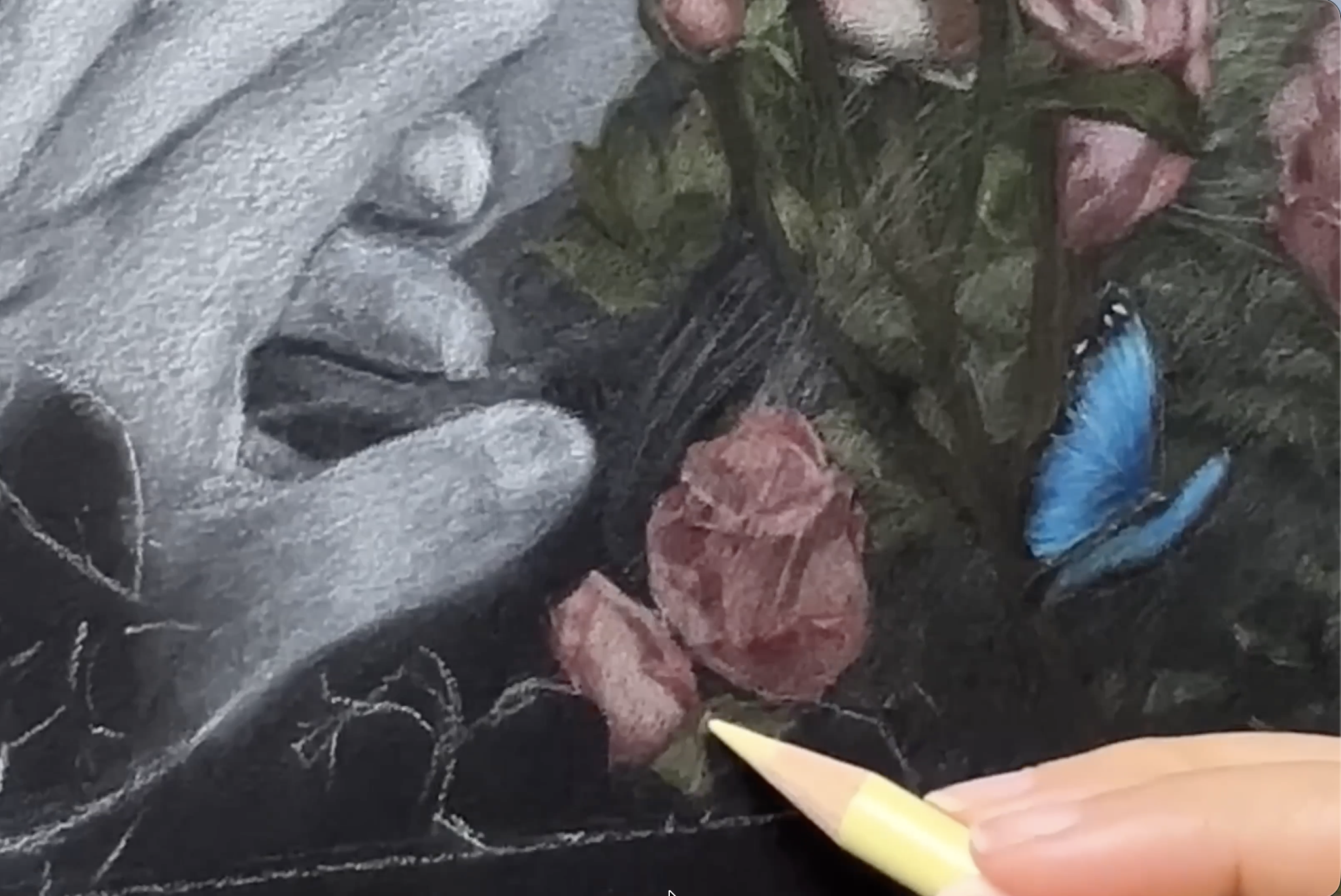An artist draws flowers using colored pencils.