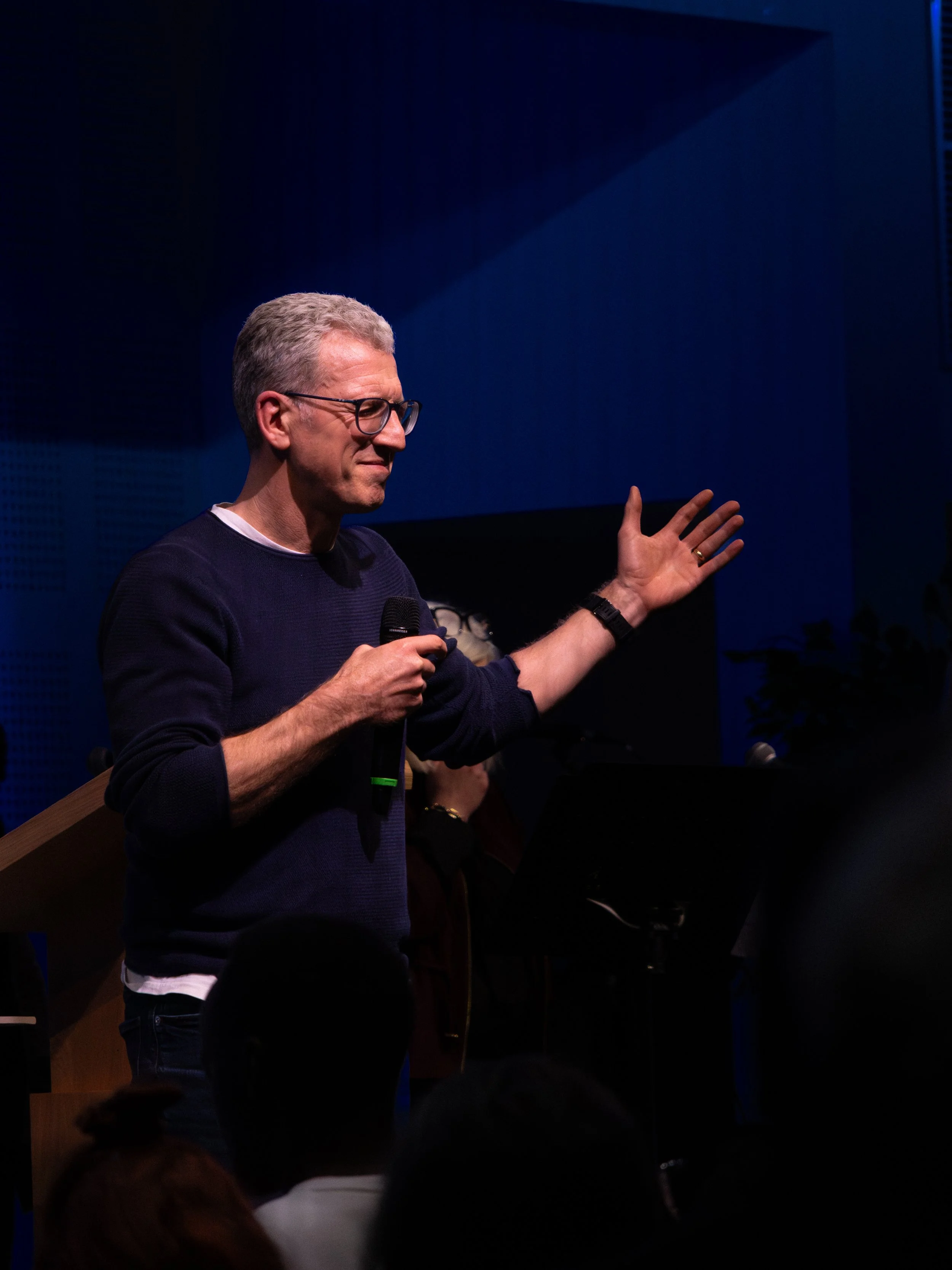A man praying with his hand raised