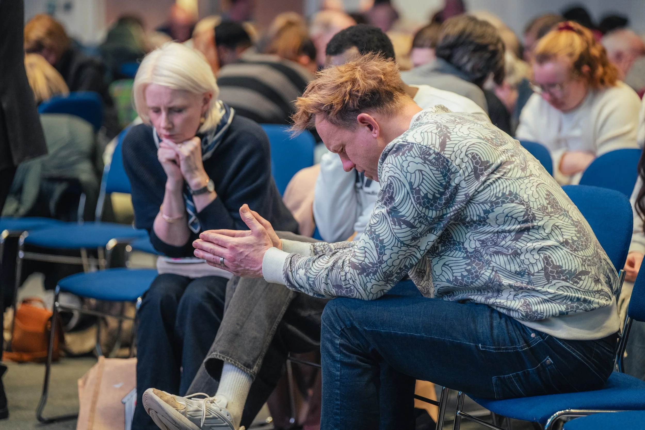 A group of men and women praying together
