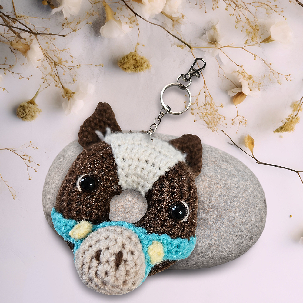 brown crochet horse in doughnut form with blue bridle and keychain