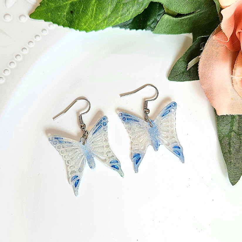White+and+blue+lacey+Butterfly+Earrings.png