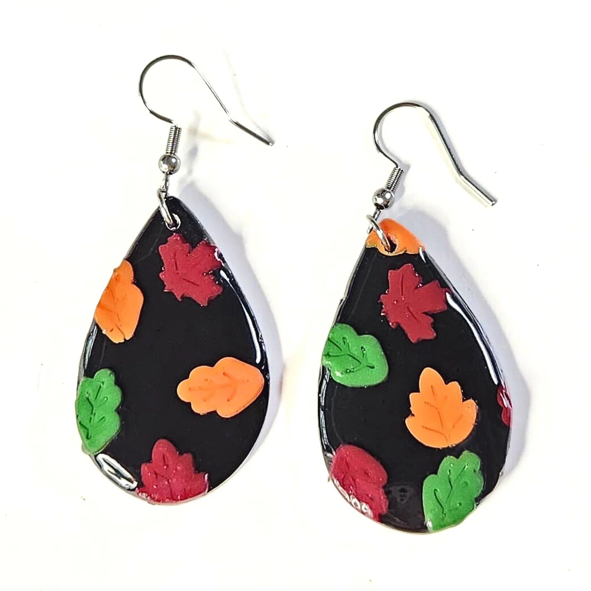 black teardrop clay earrings with fall colored leaves