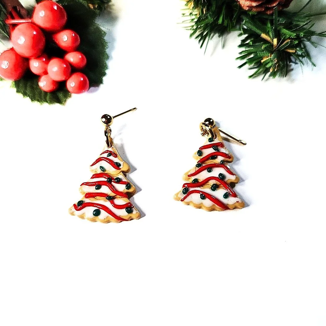 Christmas Tree Earrings, resembling white frosted tree cakes with red and green decor