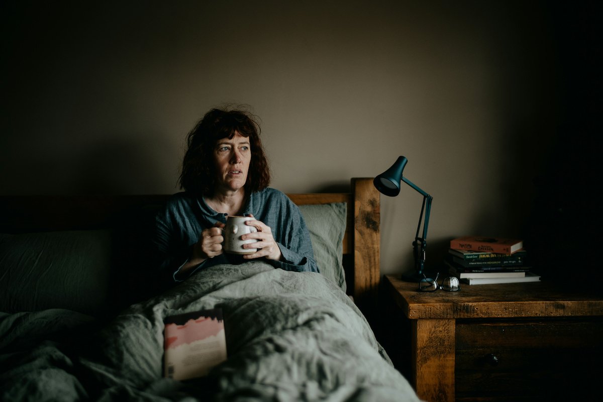 Midlife woman with insomnia. Symbolizing perimenopause transition, which can lead to anxiety, depression, irritability, leaving women needing support and resources, like online therapy for women, offered by Latina therapist in Houston, Texas