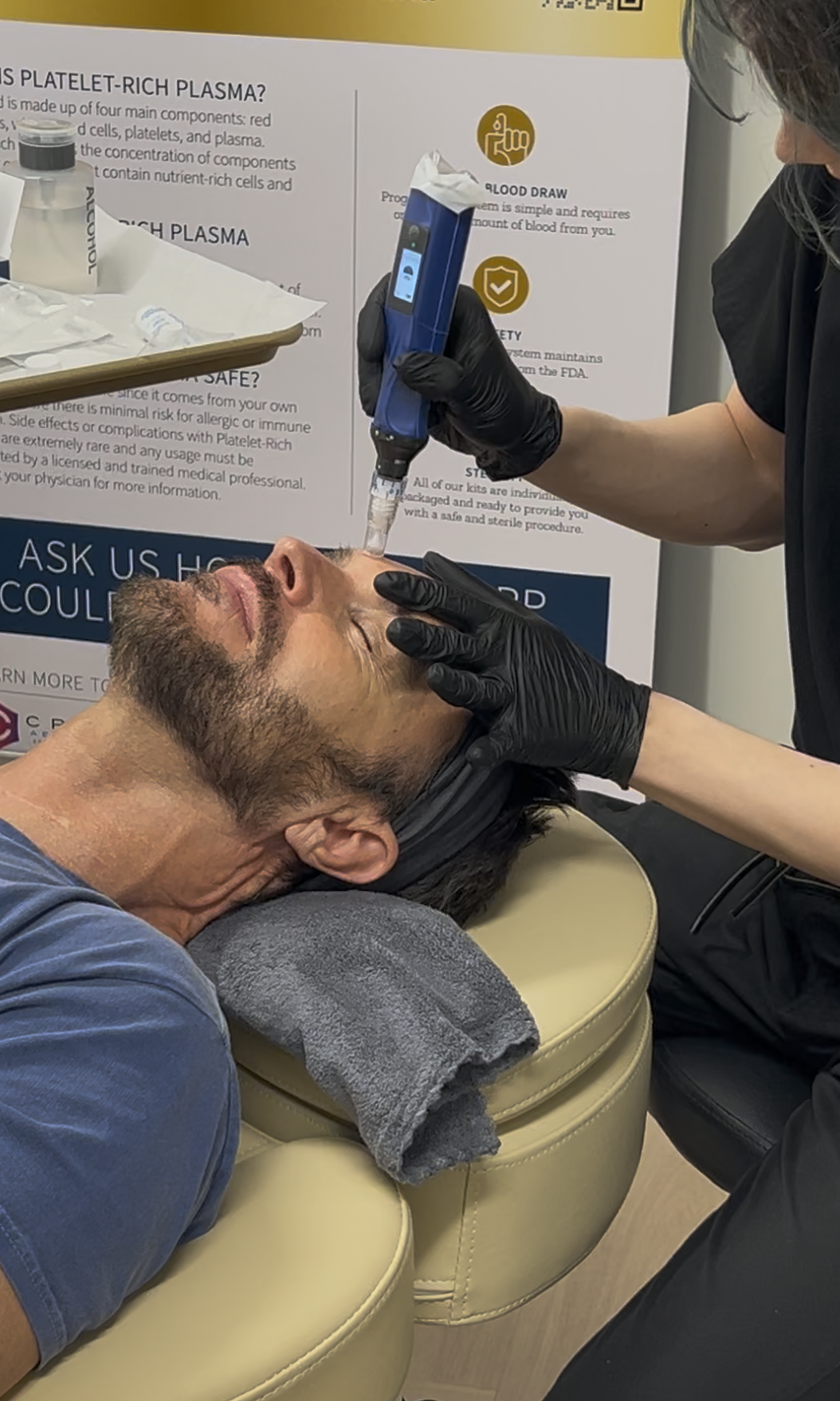 A man receiving a platelet-rich plasma (PRP) treatment on his face from a healthcare worker in a medical setting.