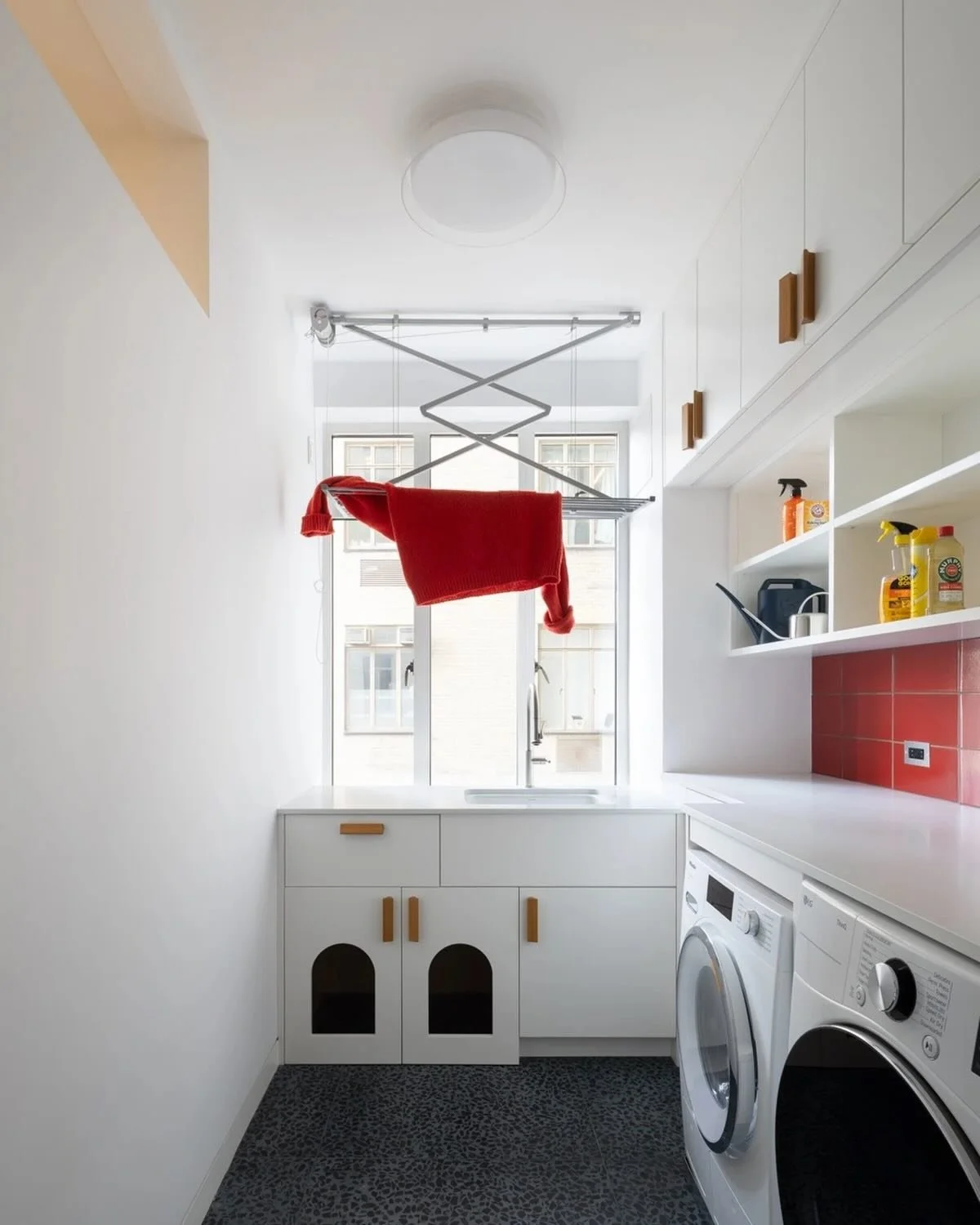 In our UWS kitchen project, the laundry room serves many roles: cleaning, service entry, storage, and 🐈🐈&zwj;⬛. Yet, it&rsquo;s still a design opportunity with a bold red tile and terrazzo floor.  Photo @devonbanksphoto.  This project is featured i
