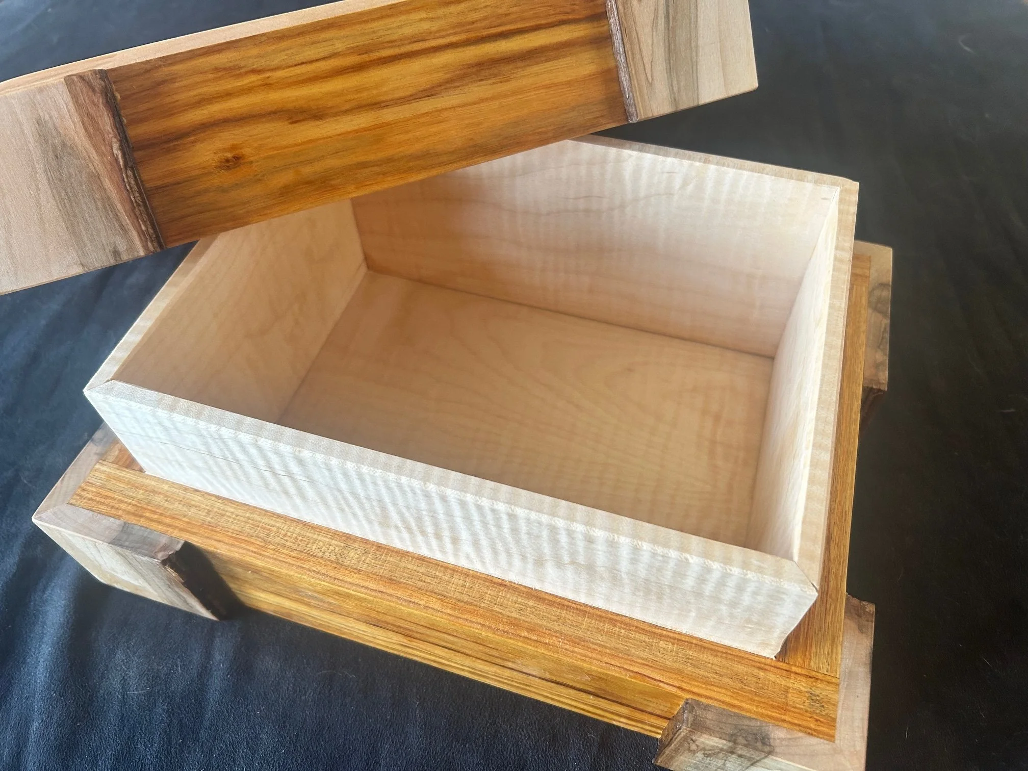 Canarywood keepsake box with tiger maple interior/top and spalted maple accent corners.