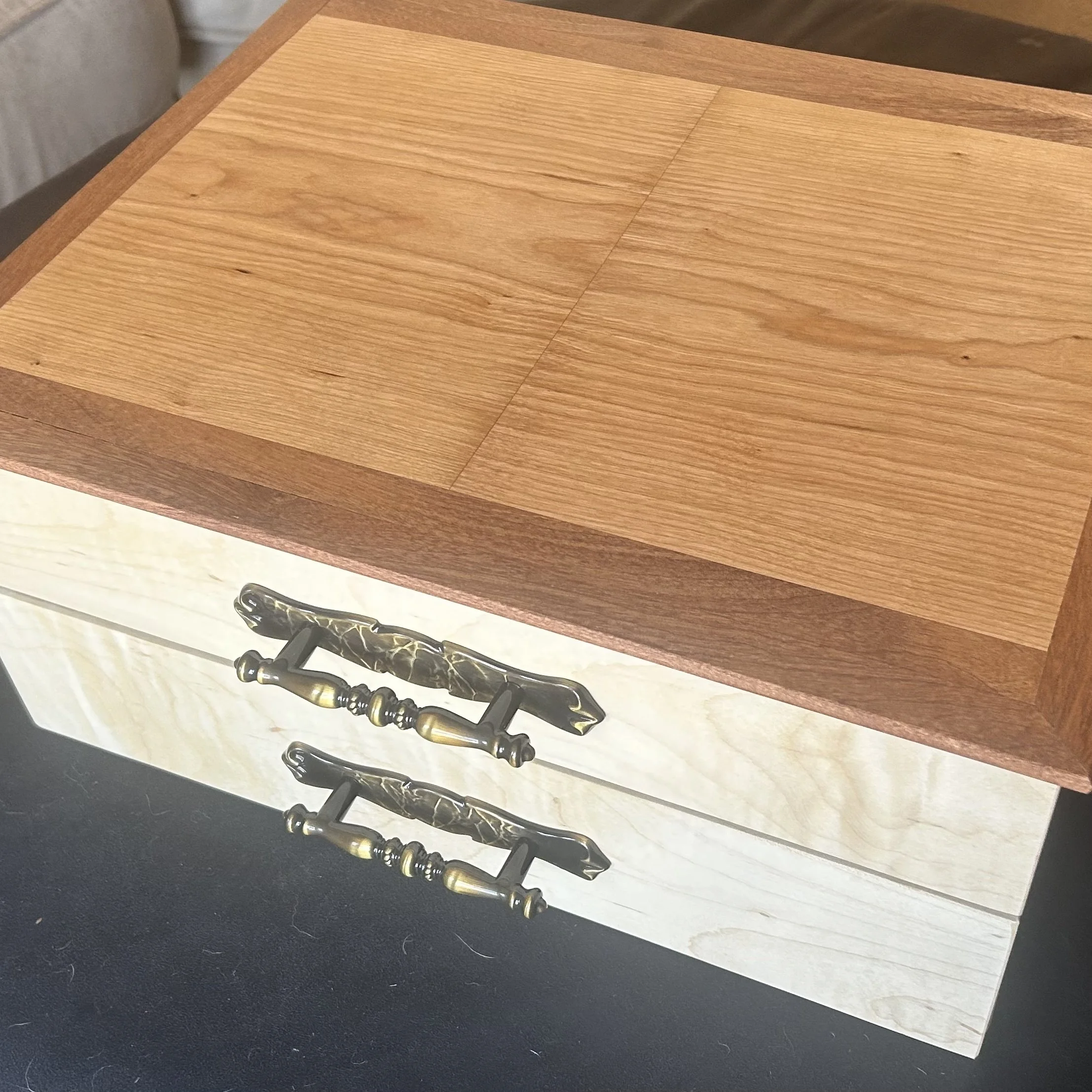 Small drawer chest made out of cherry, with sapele mahogany trim and figured maple drawer fronts.