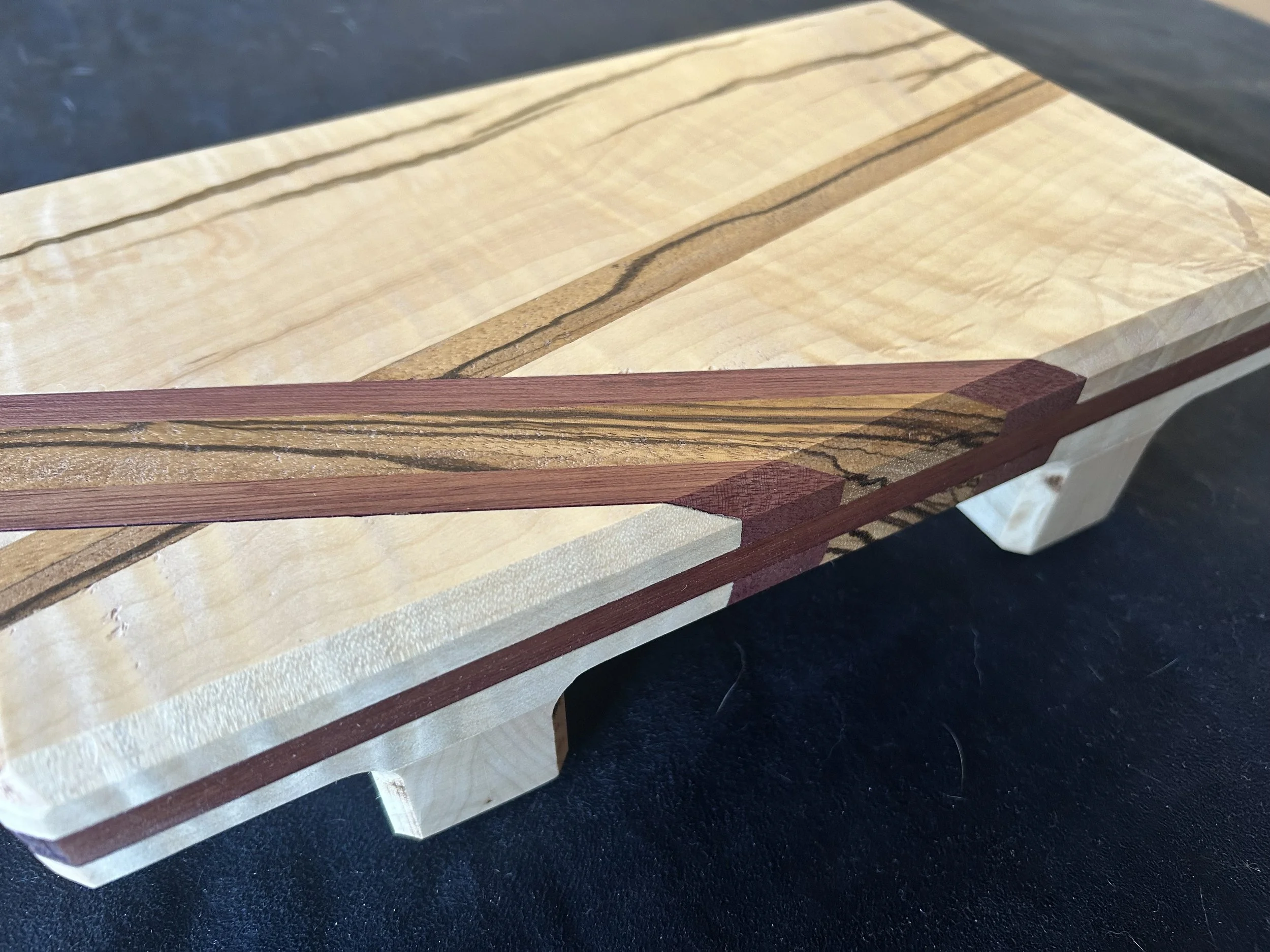 Seasoning stand / trivet made from figured maple with purpleheart and zebra wood accents.