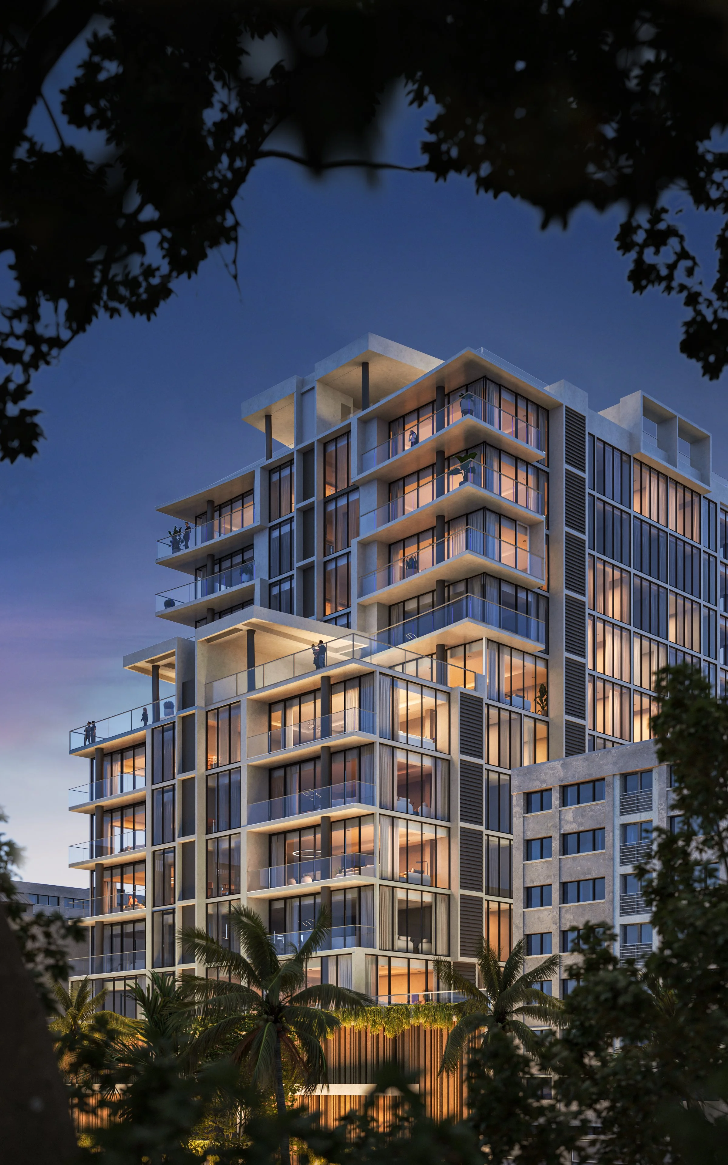 Modern multi-story residential building with large glass windows and balconies, surrounded by trees at dusk.