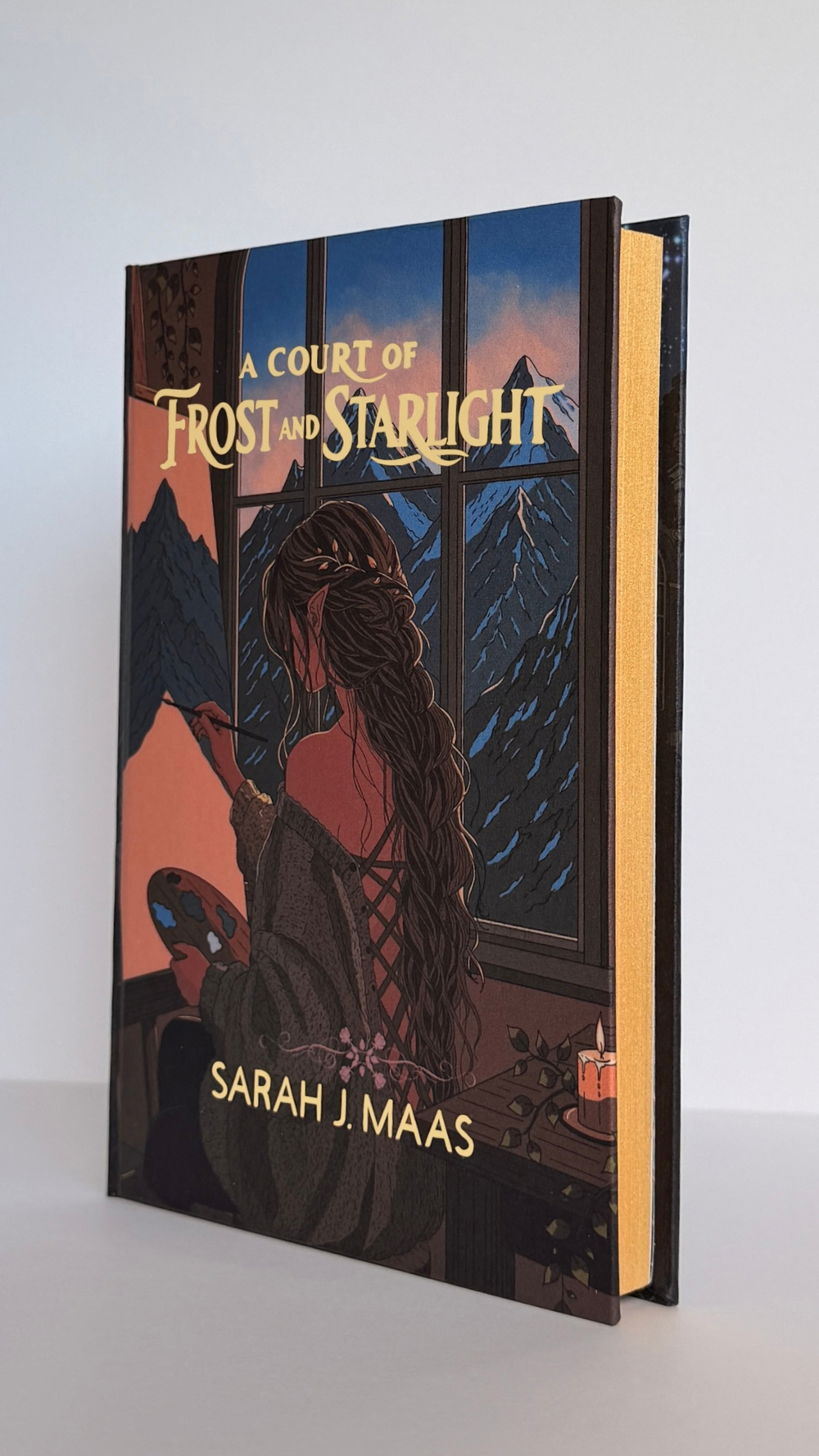A Court of Frost and Starlight handbound edition, showing the foiled spine and the illustrated cover.