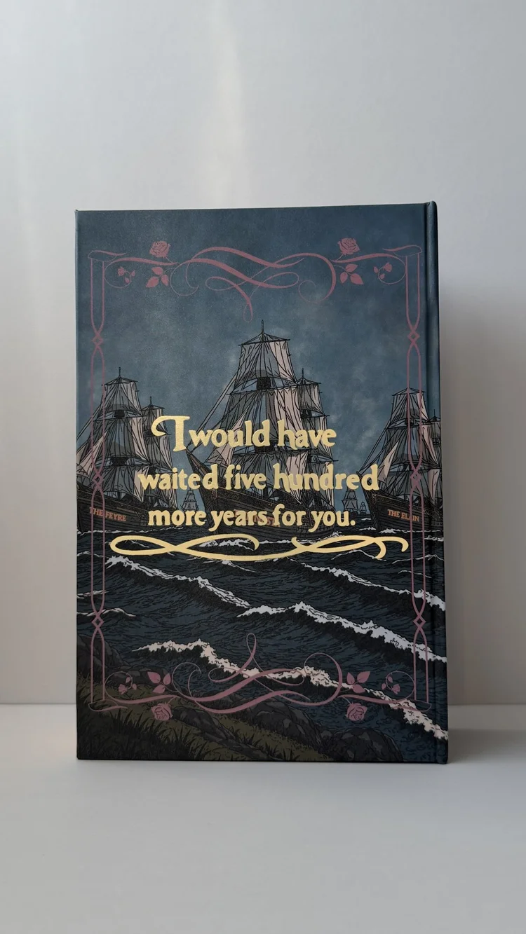The back cover: an armada standing off a dark coast, with a foiled quote above the water.