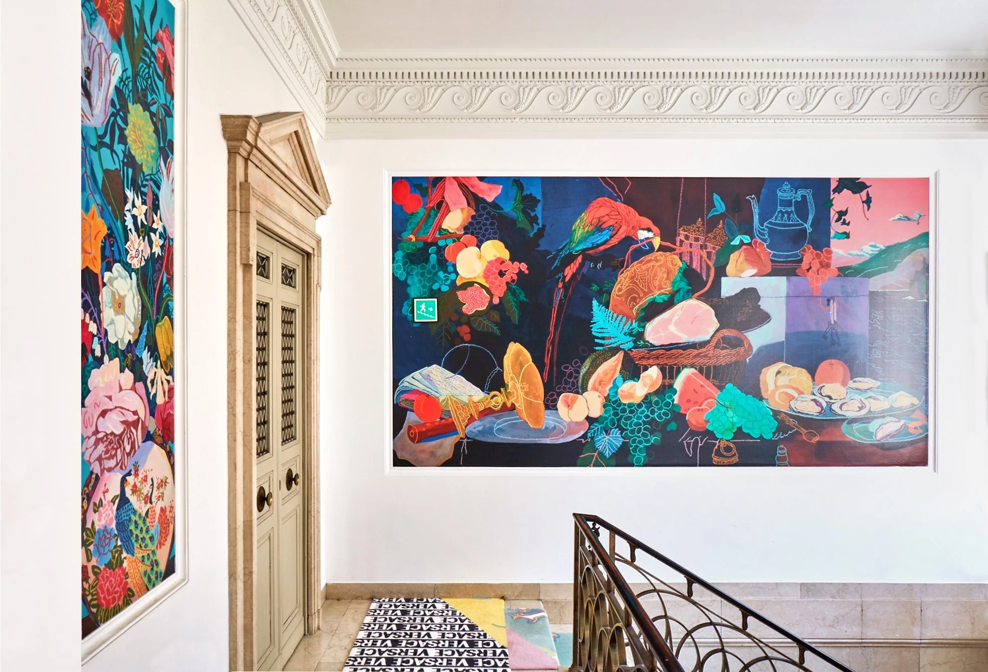 Colorful artwork on the museum walls depicting a still life scene with fruits, a parrot, and various objects.