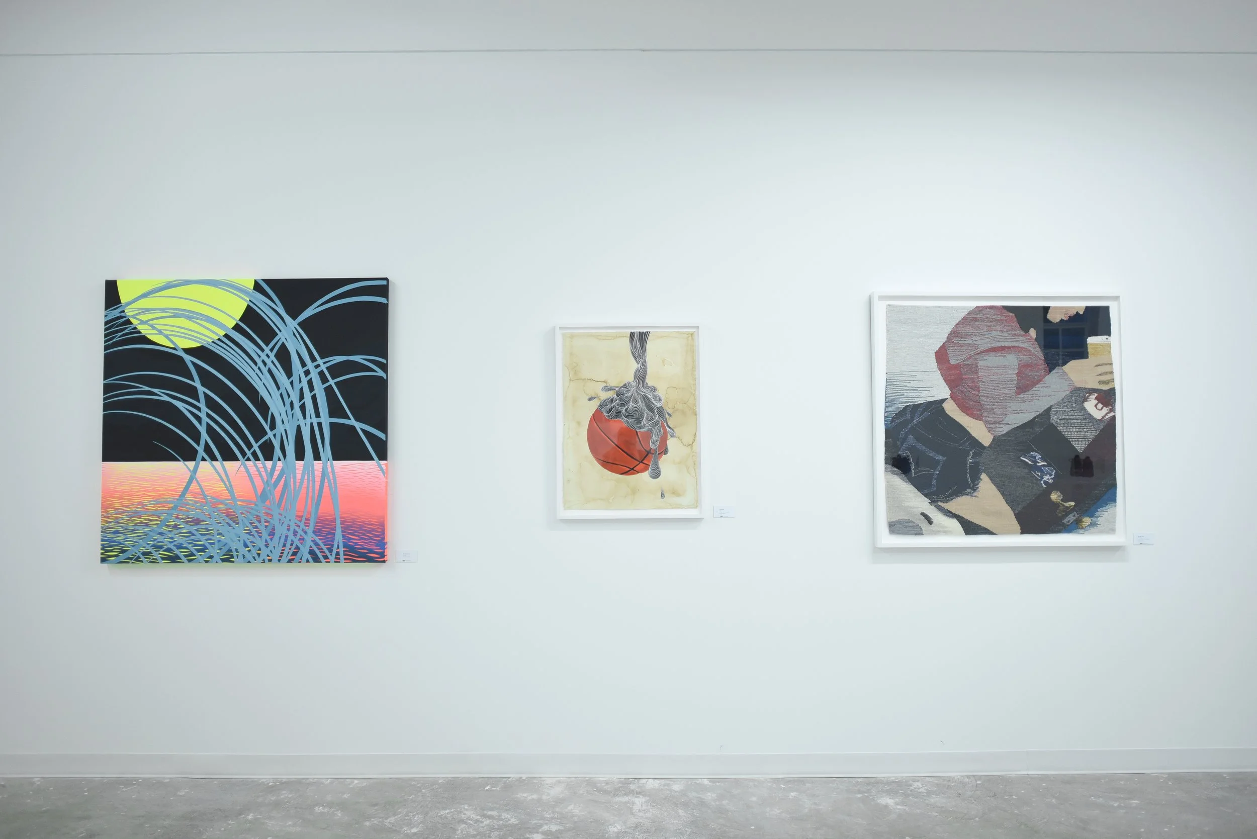 Three colorful artworks displayed on a white gallery wall, featuring abstract and figurative styles in a modern art setting.