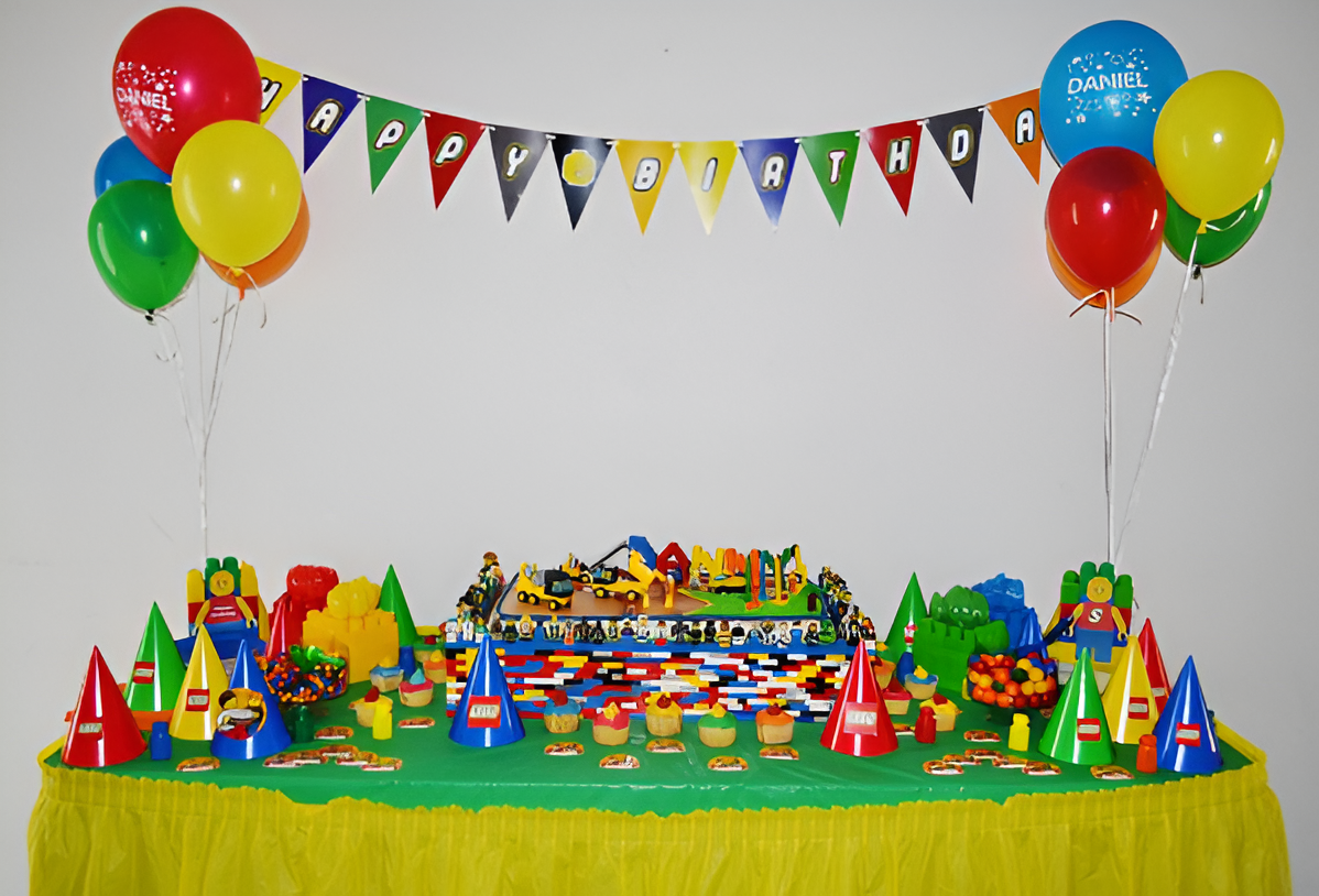 Colorful birthday party setup with balloons, a decorated table, and a "Happy Birthday" banner.