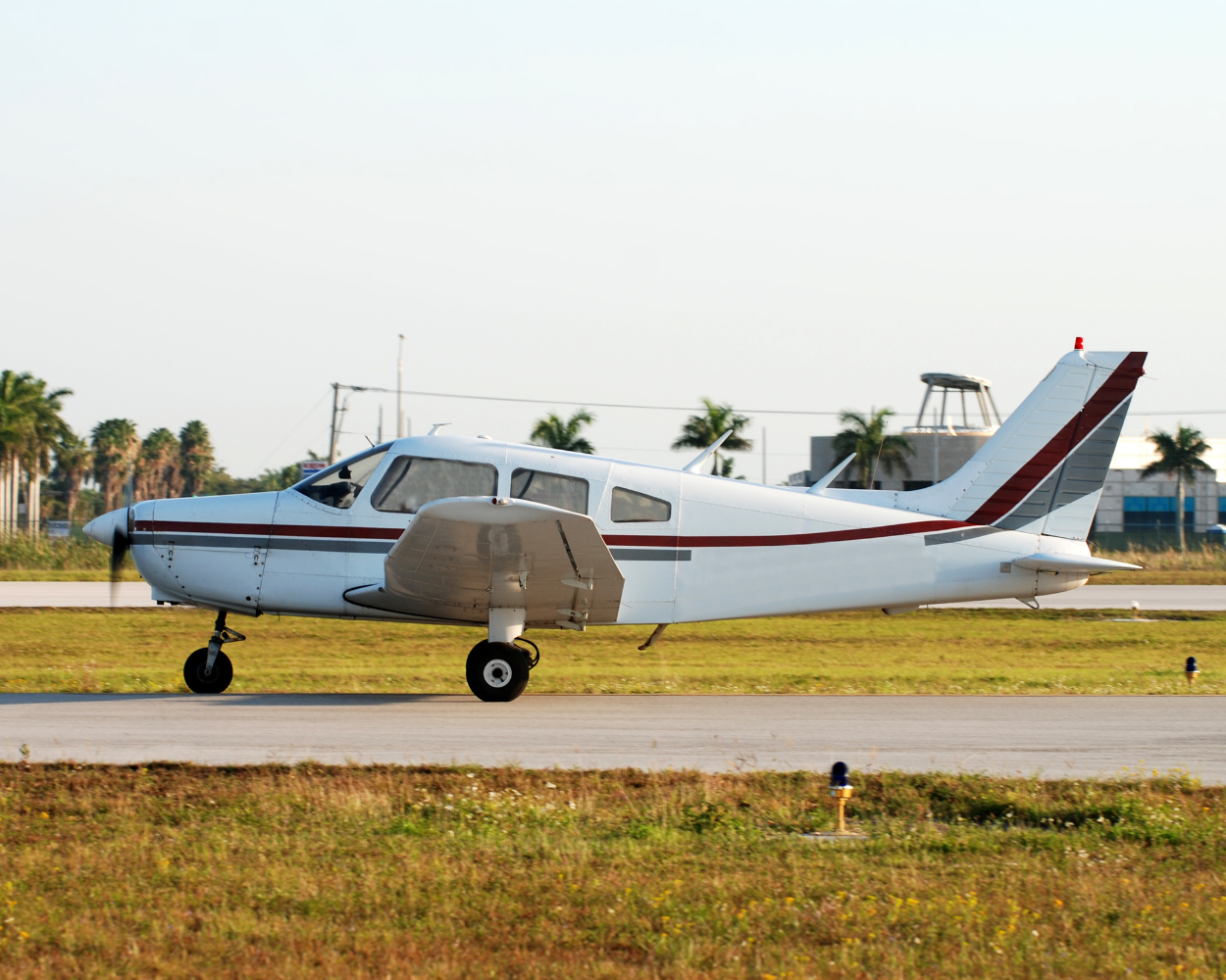 Single-engine aircraft preparing for dispatch on an empty airstrip