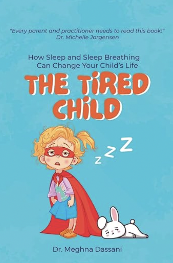 Book cover titled 'The Tired Child' by Dr. Meghna Dassani, featuring a cartoon illustration of a sleepy child with red glasses and a red cape, with a white bunny lying down.