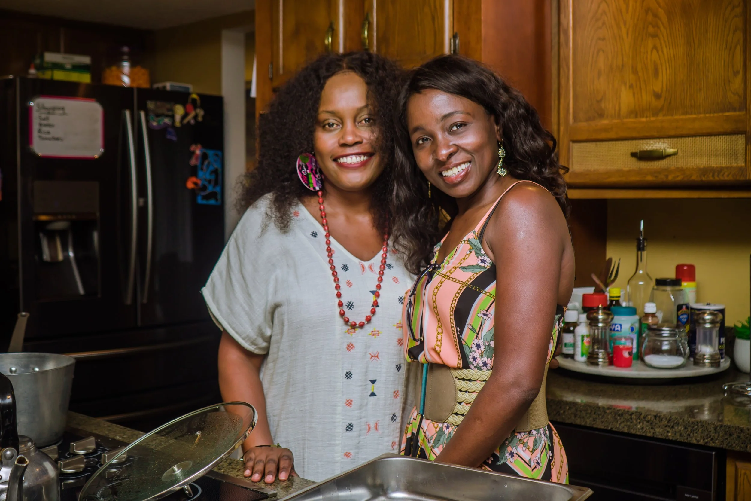 Two women smiling in a kitchen.