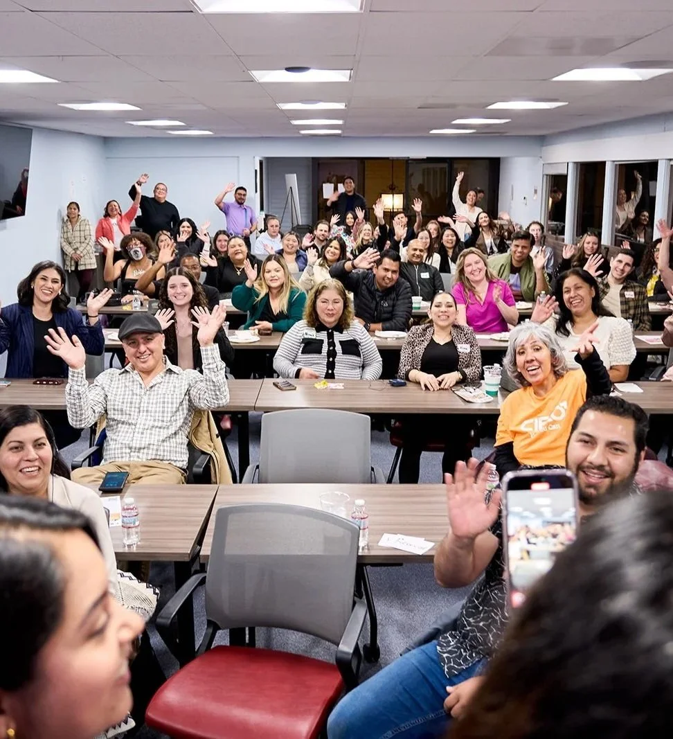 A room of 50+ business professionals at a marketing mixer held in a conference room.