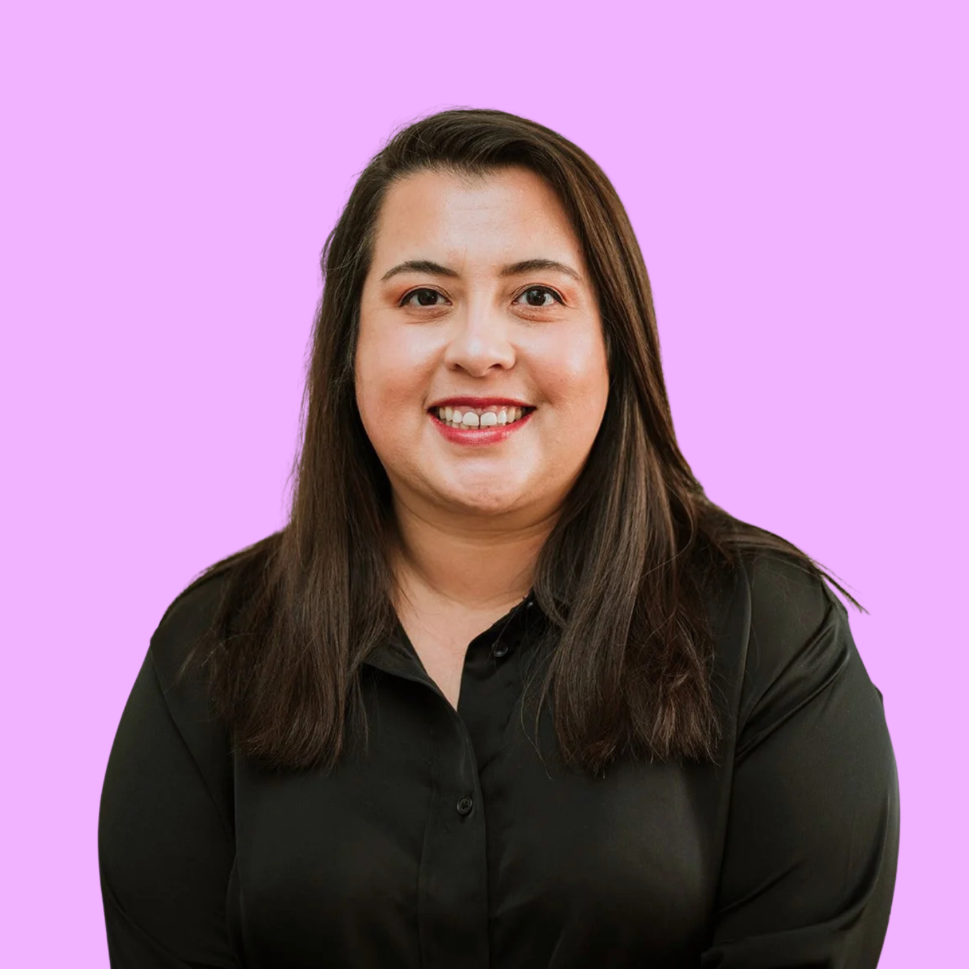 A woman with shoulder-length dark hair, wearing a black shirt, smiling against a purple background.