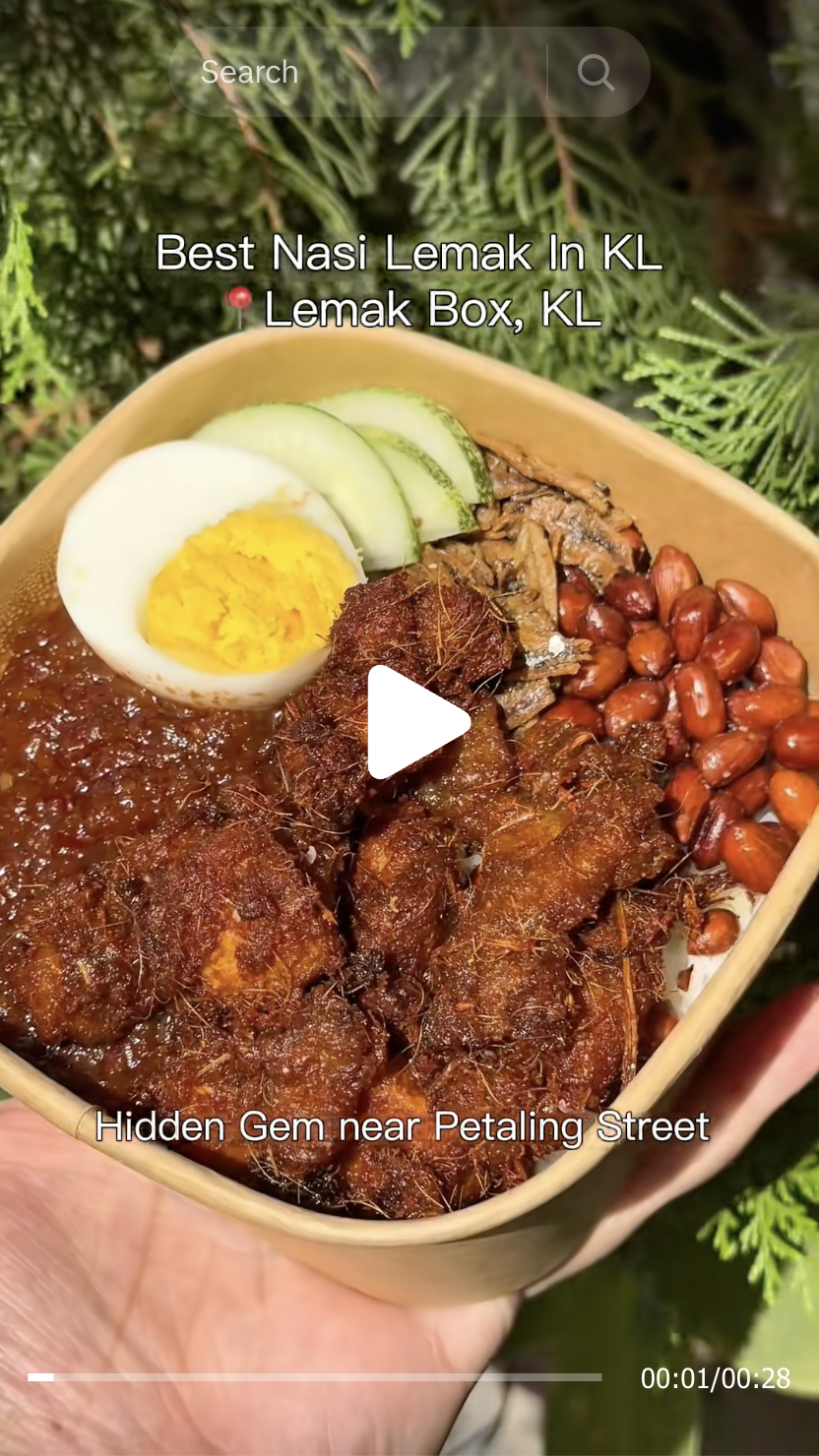 KL Food reviewer tastedbyangel holding the best affordable nasi lemak under RM10 at LemakBox Chinatown KL