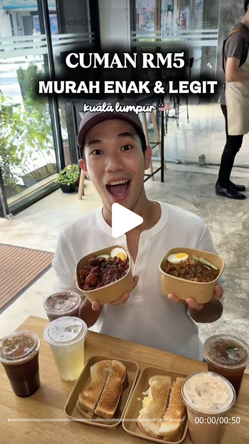 Indonesian food creator June holding a LemakBox Nasi Lemak Ayam Berempah and Mee Siam ayam merah box at Petaling Street KL