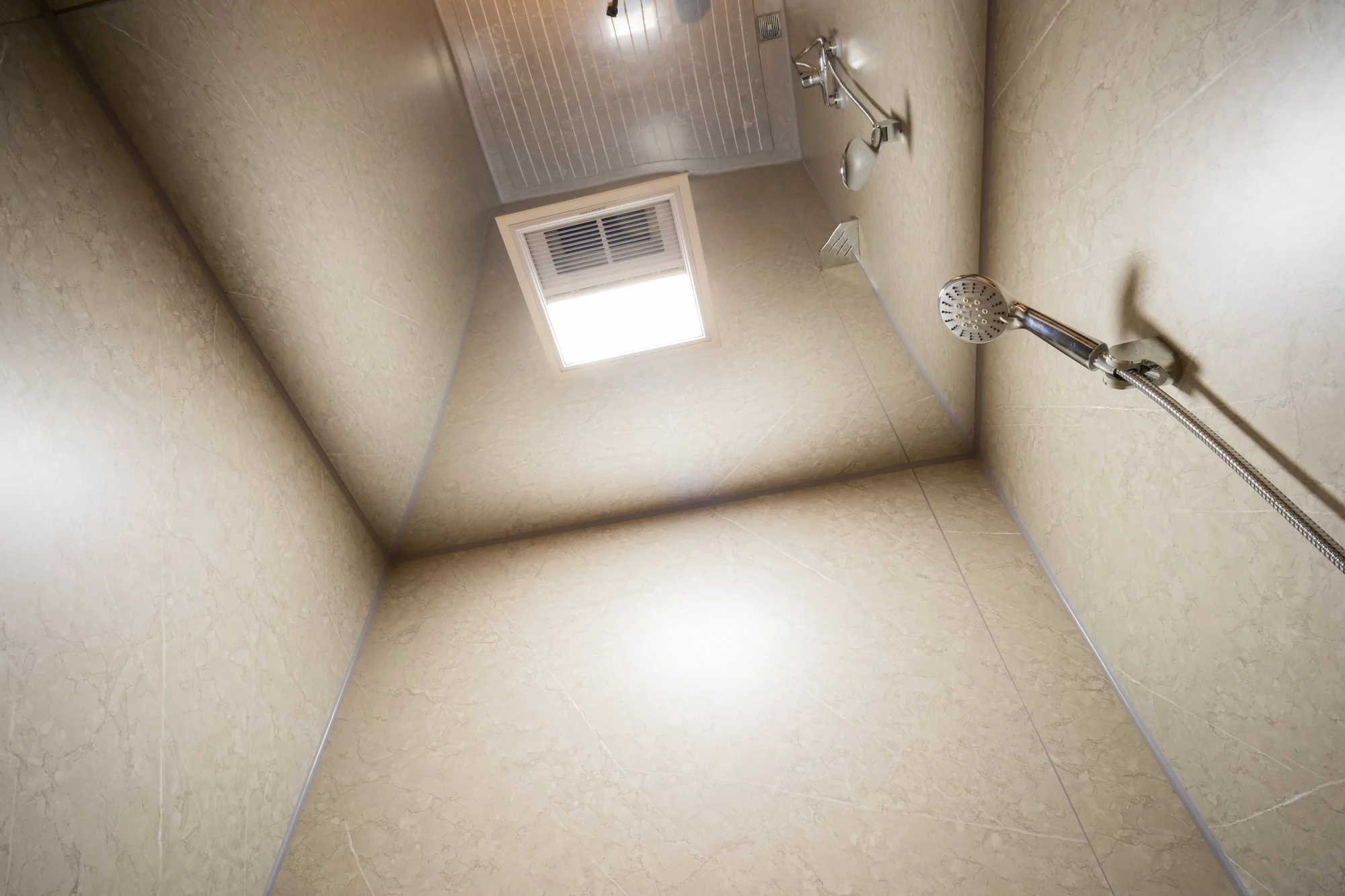 AUZPOD bathroom shower ceiling with window, ventilation vent, and wall-mounted handheld showerhead in a sustainable modular pod house.








Ask ChatGPT
