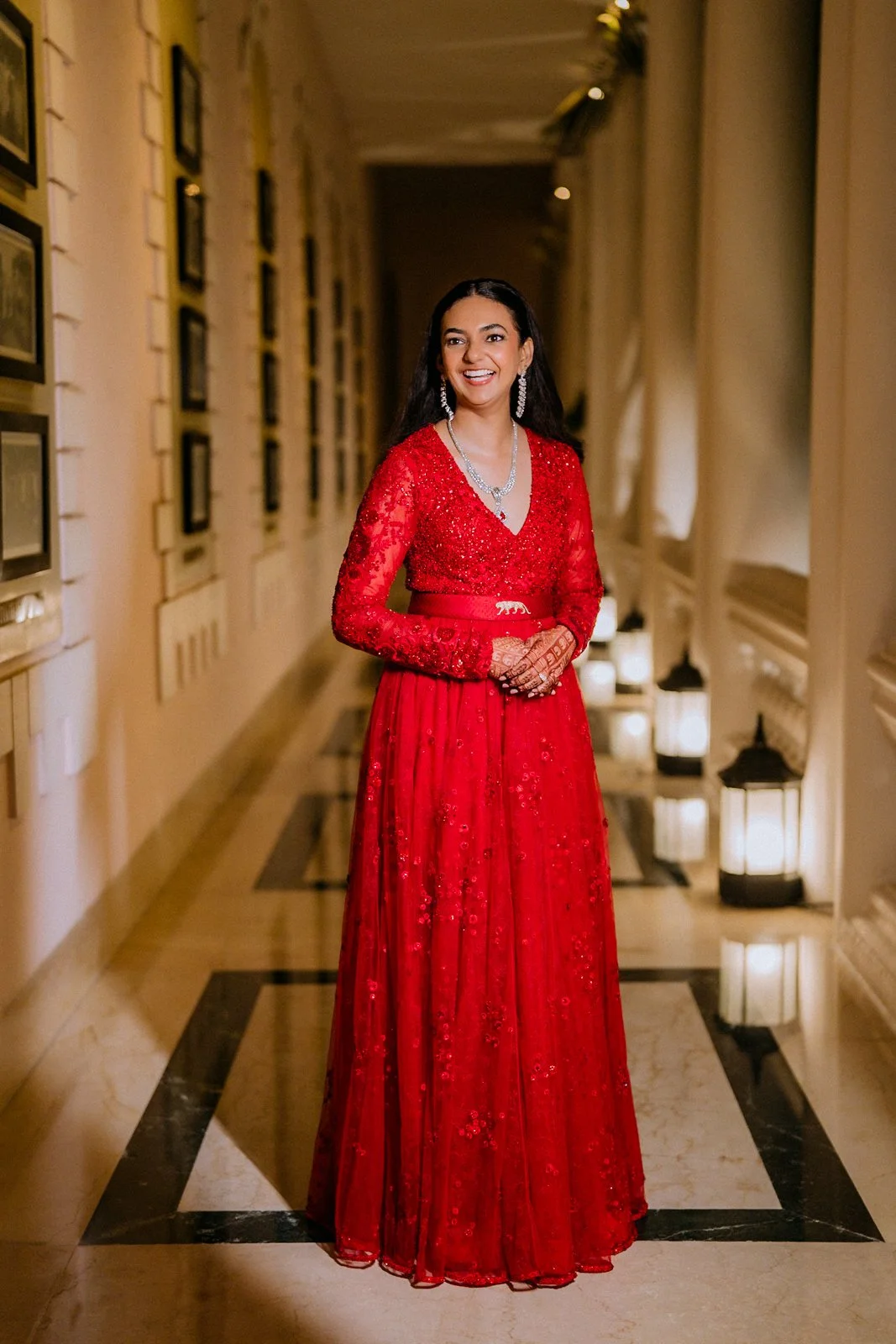 Shrishti in her red gown in the Taj West End corridor
