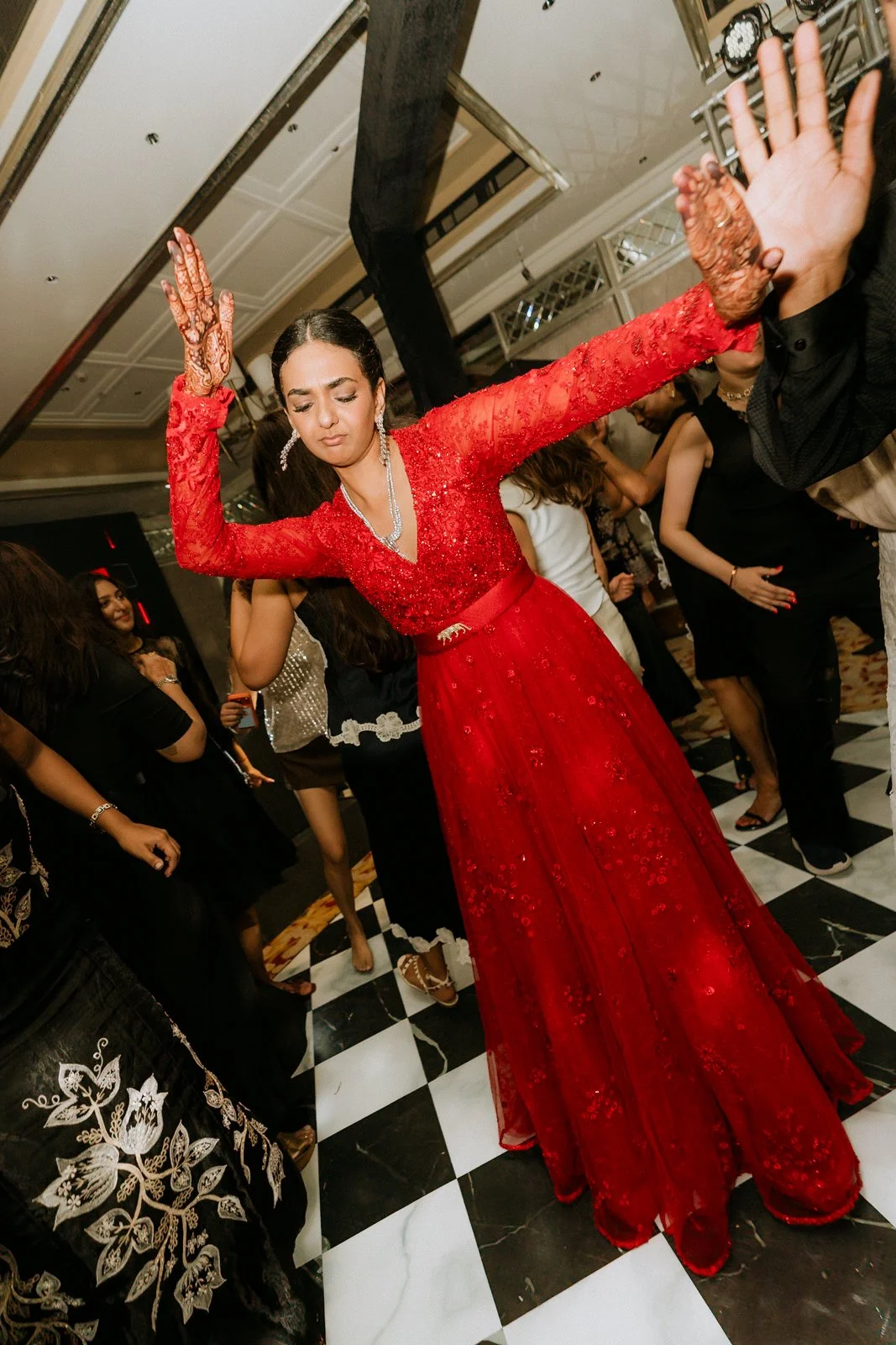 Shrishti dancing with her arms raised