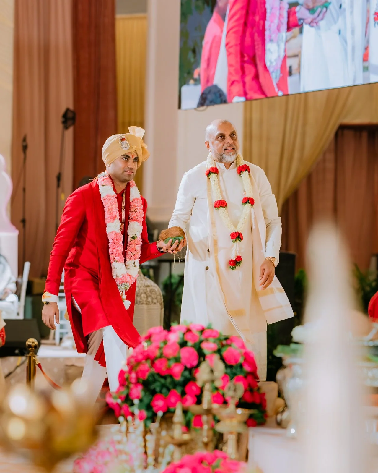 Akhil walking in to the mandap with his father