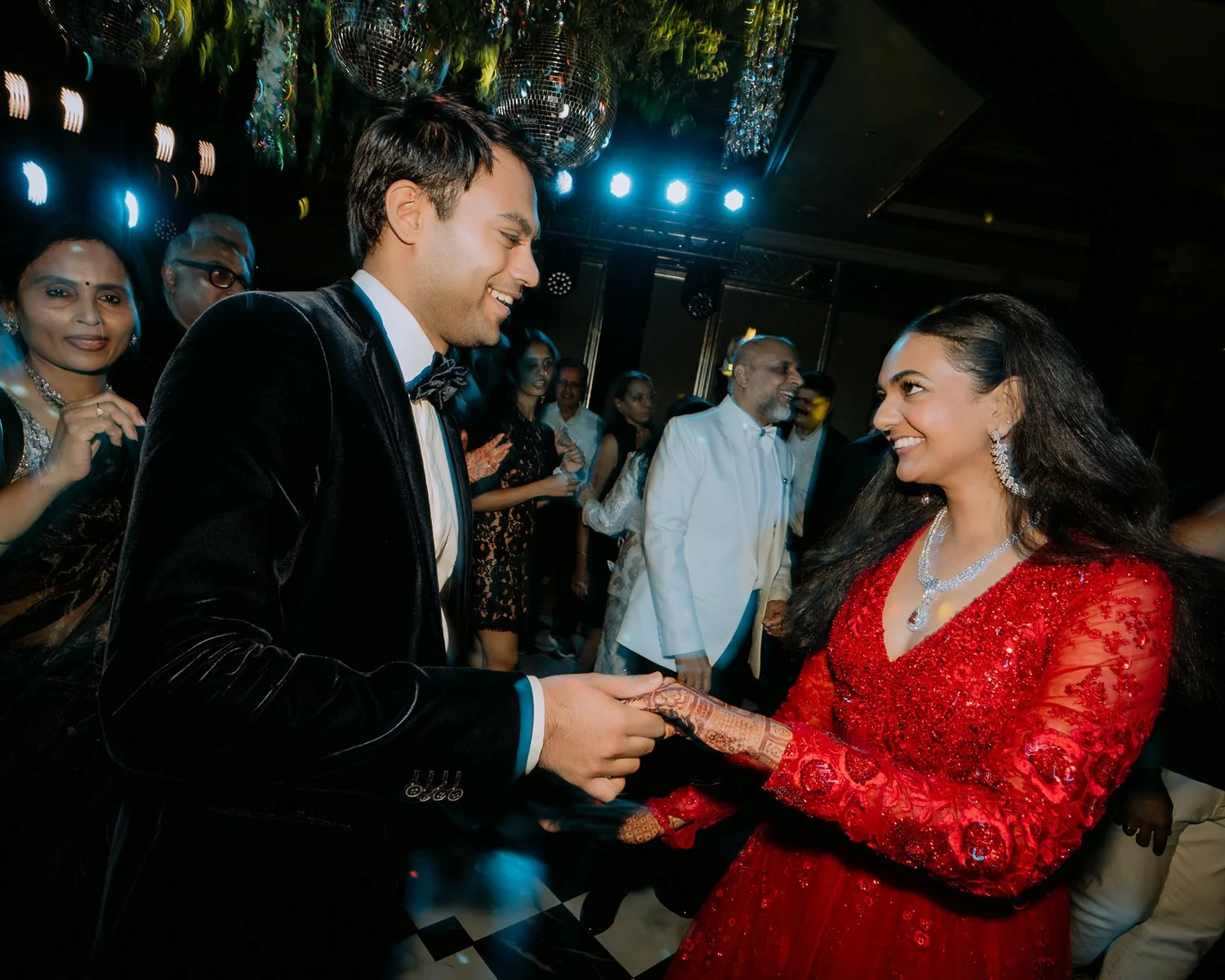Akhil and Shrishti holding hands on the dance floor