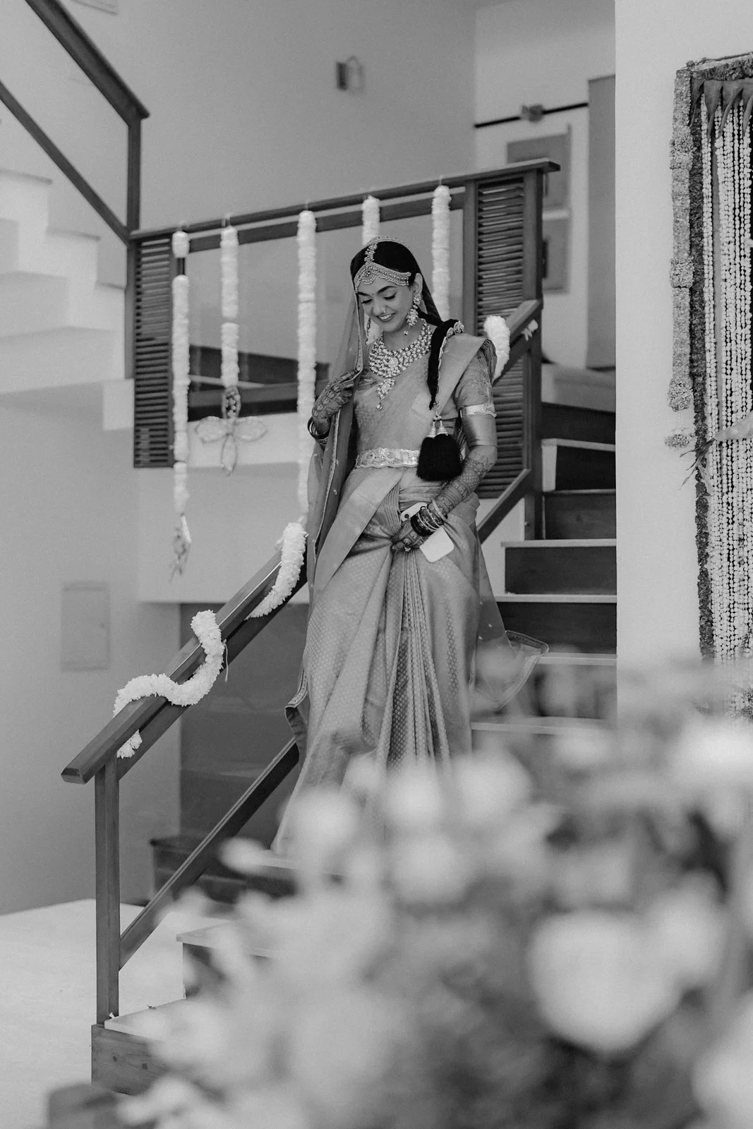 Shrishti coming down the stairs in her bridal saree, black and white