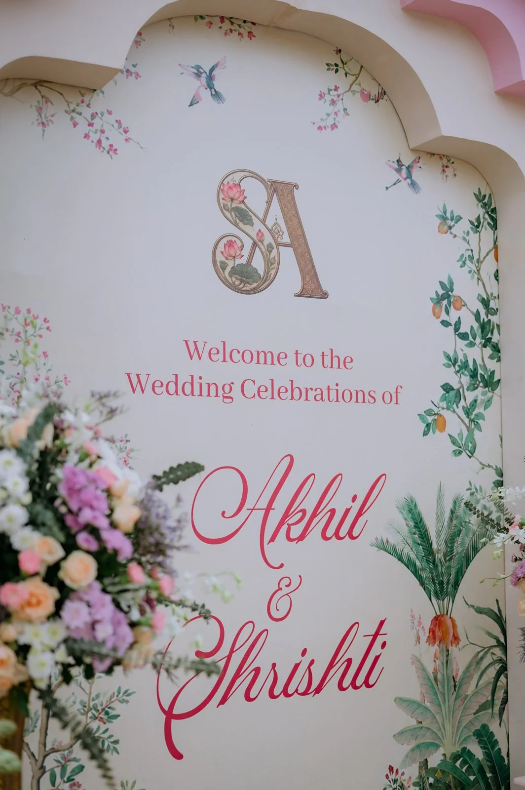 Welcome board reading Akhil and Shrishti with floral illustrations
