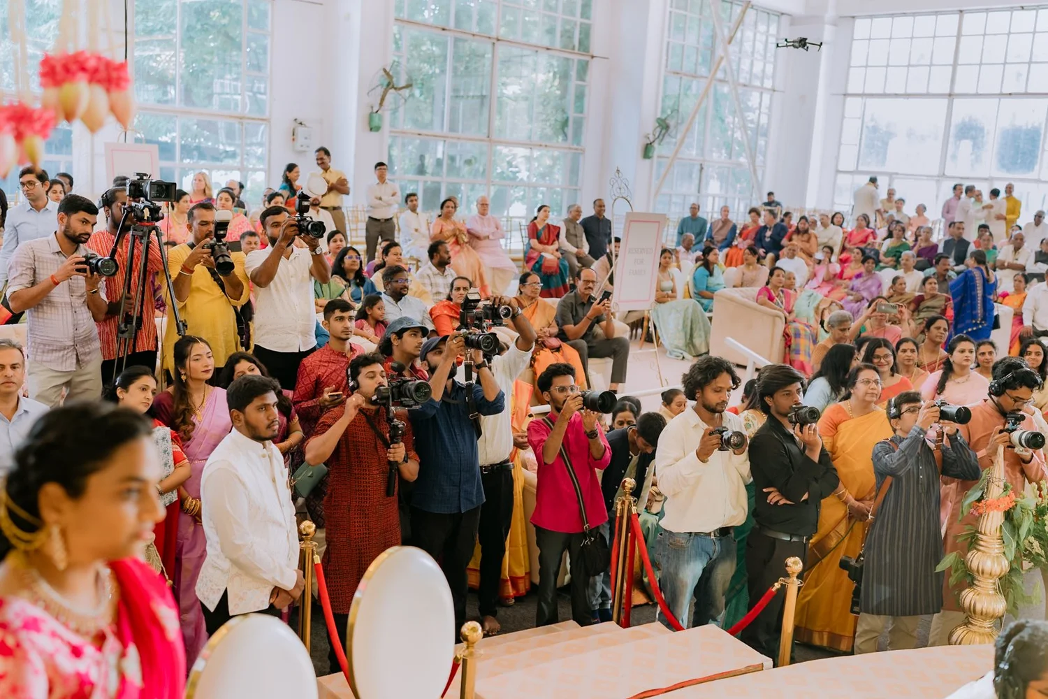 Guests and photographers gathered around the mandap