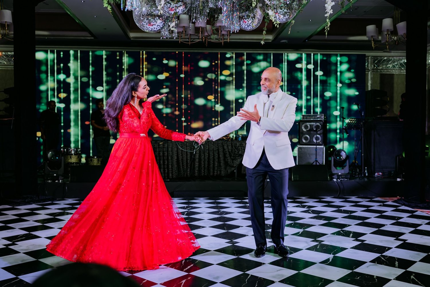 Shrishti dancing with her father on the checkerboard floor