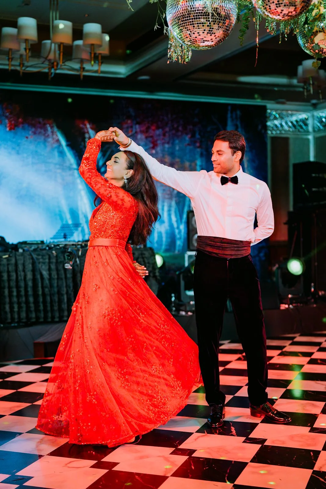 Akhil twirling Shrishti in her red gown