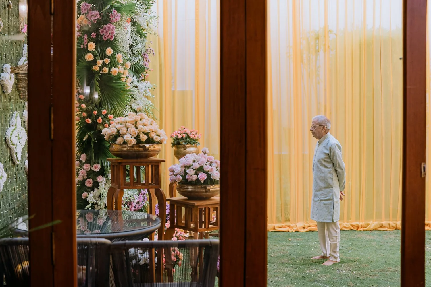 Shrishti's grandfather in the garden among the haldi decor