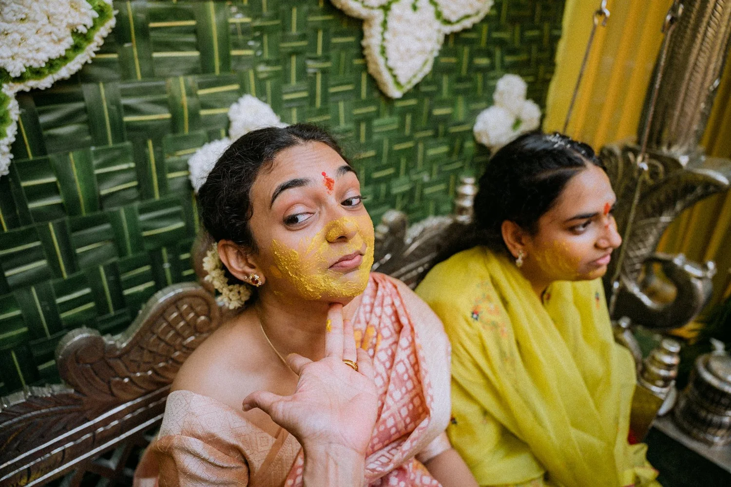 Shrishti with haldi on her face beside her sister