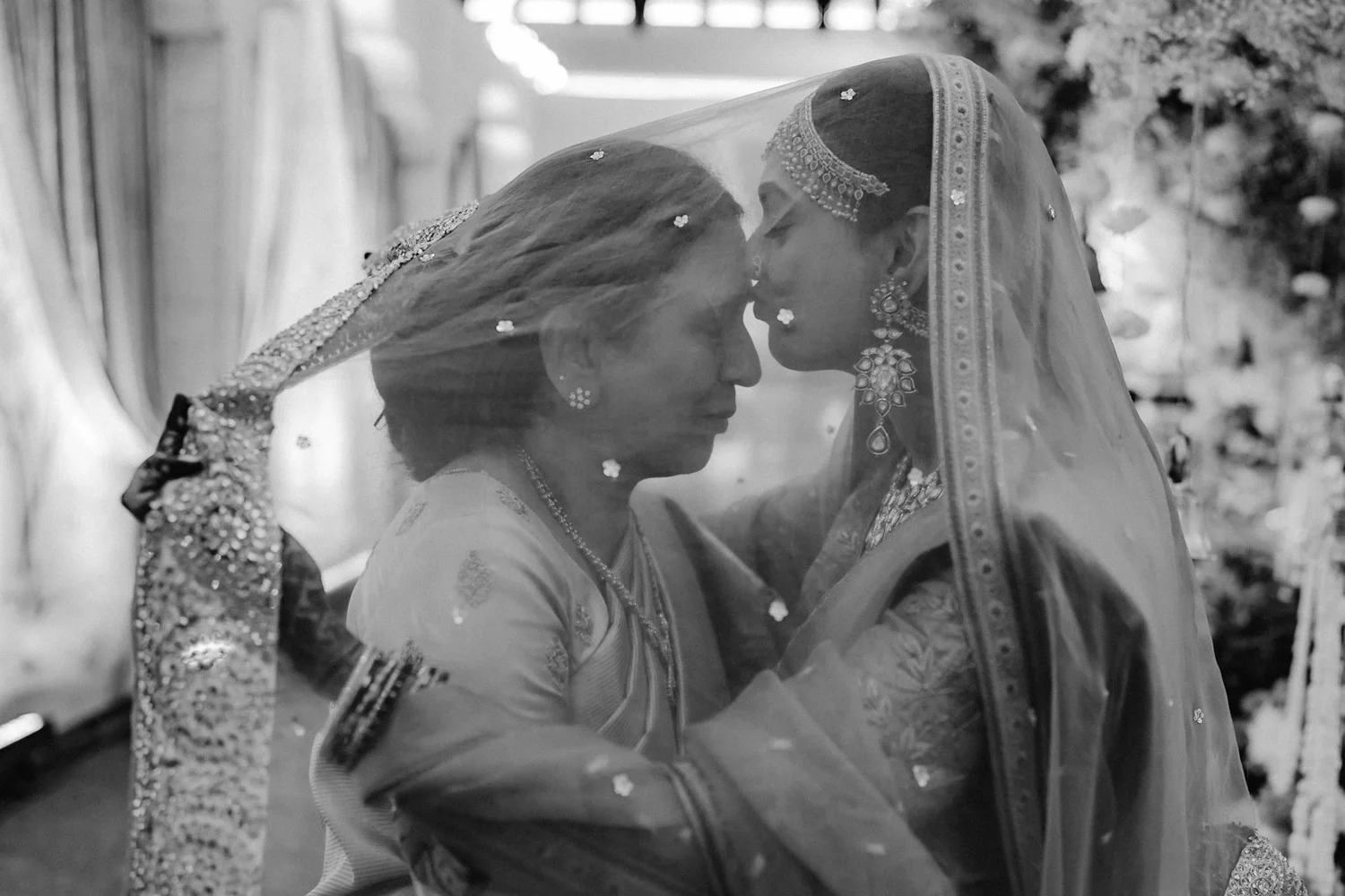 Shrishti and her mother touching foreheads under the veil, black and white