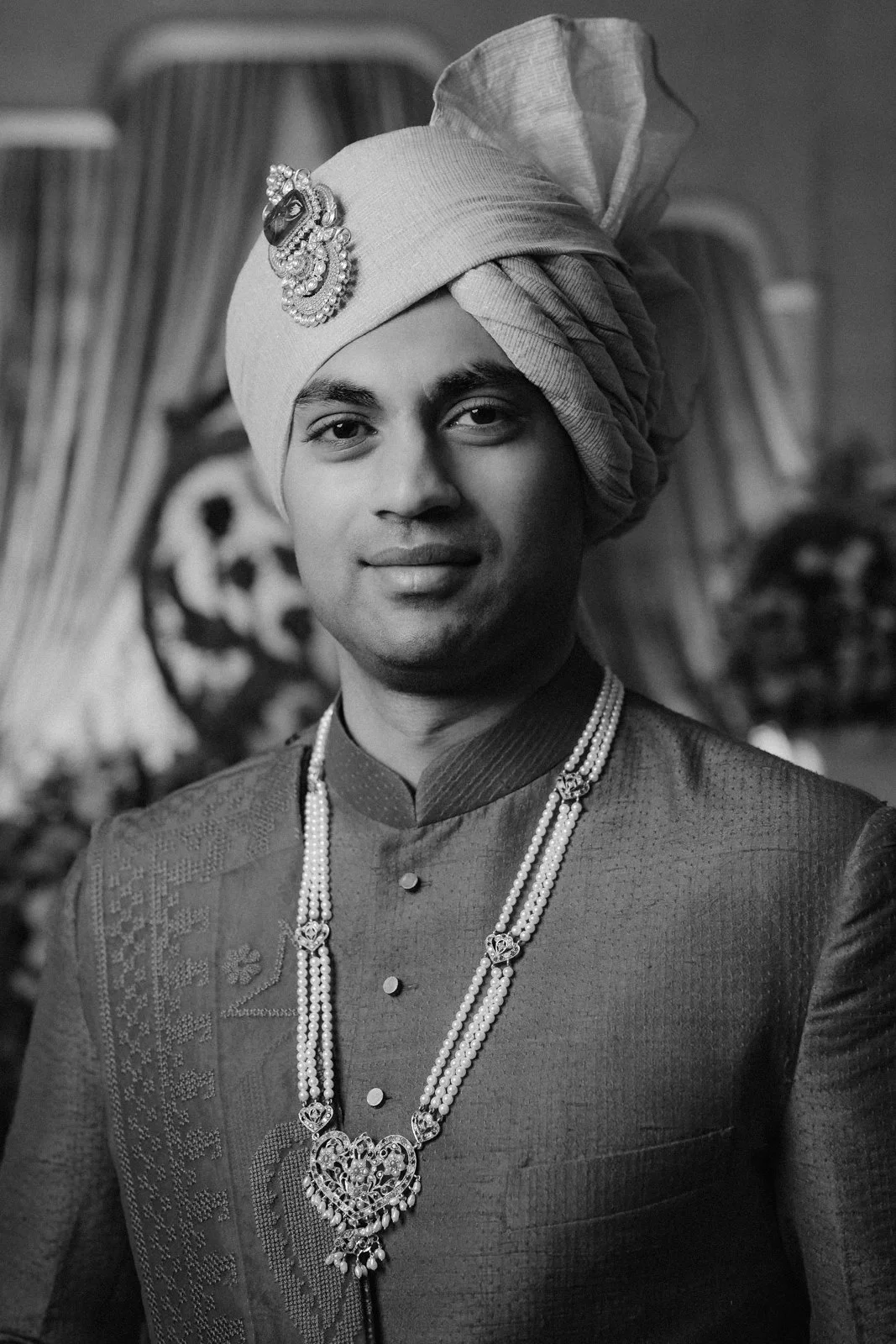 Portrait of Akhil in his safa and pearl necklace, black and white