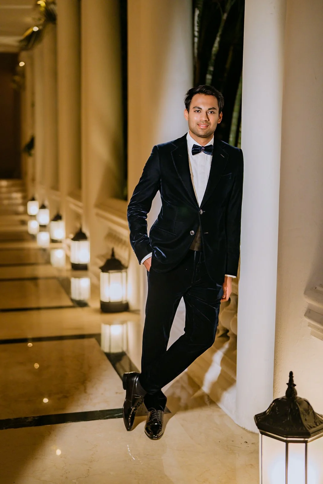 Akhil in a velvet tuxedo in the Taj West End corridor
