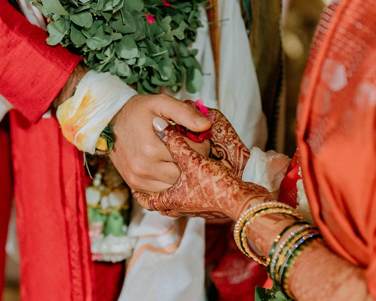 Close-up of the couple's hands joined in the kanyadaan