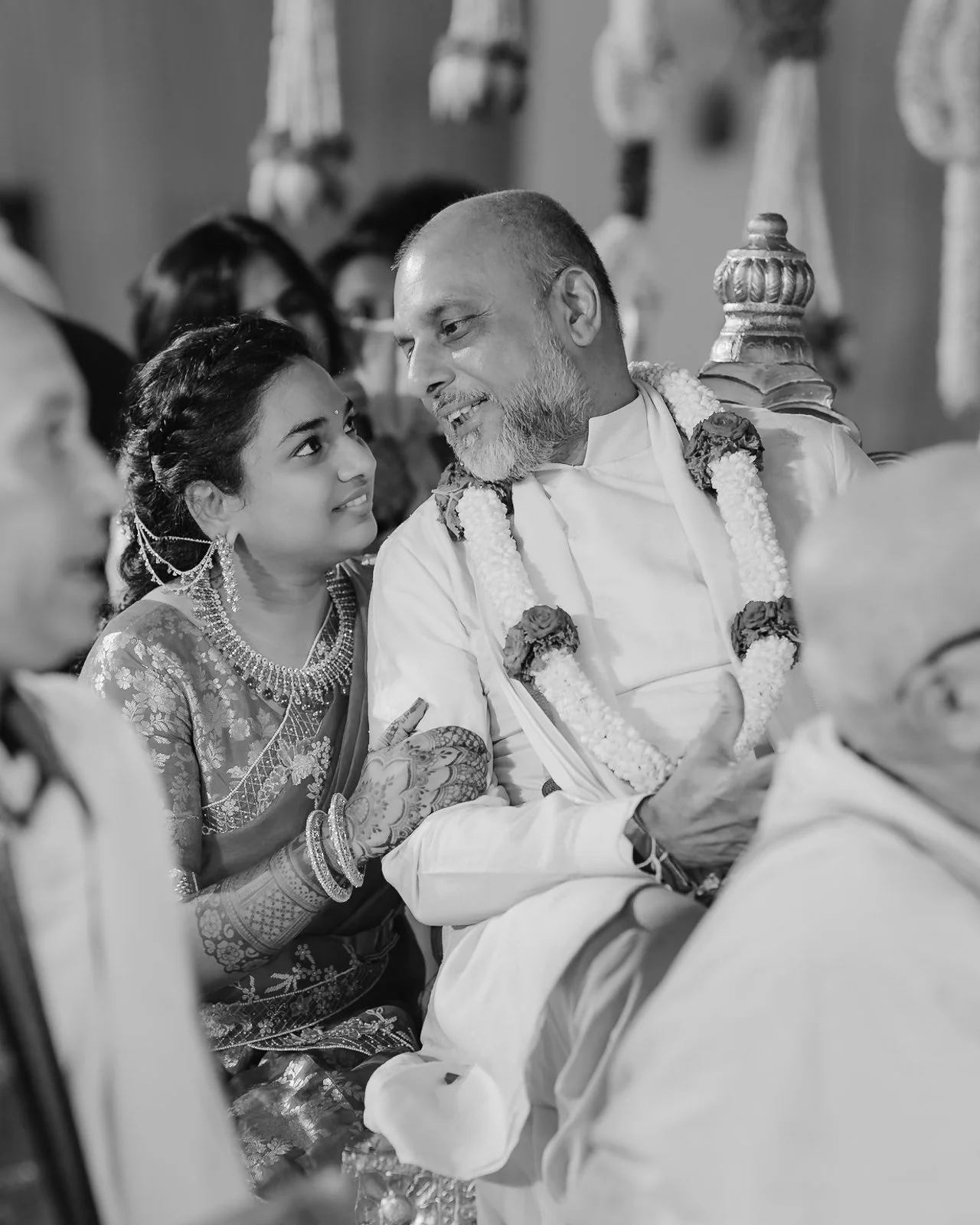 Shrishti sharing a laugh with her father during the rituals, black and white