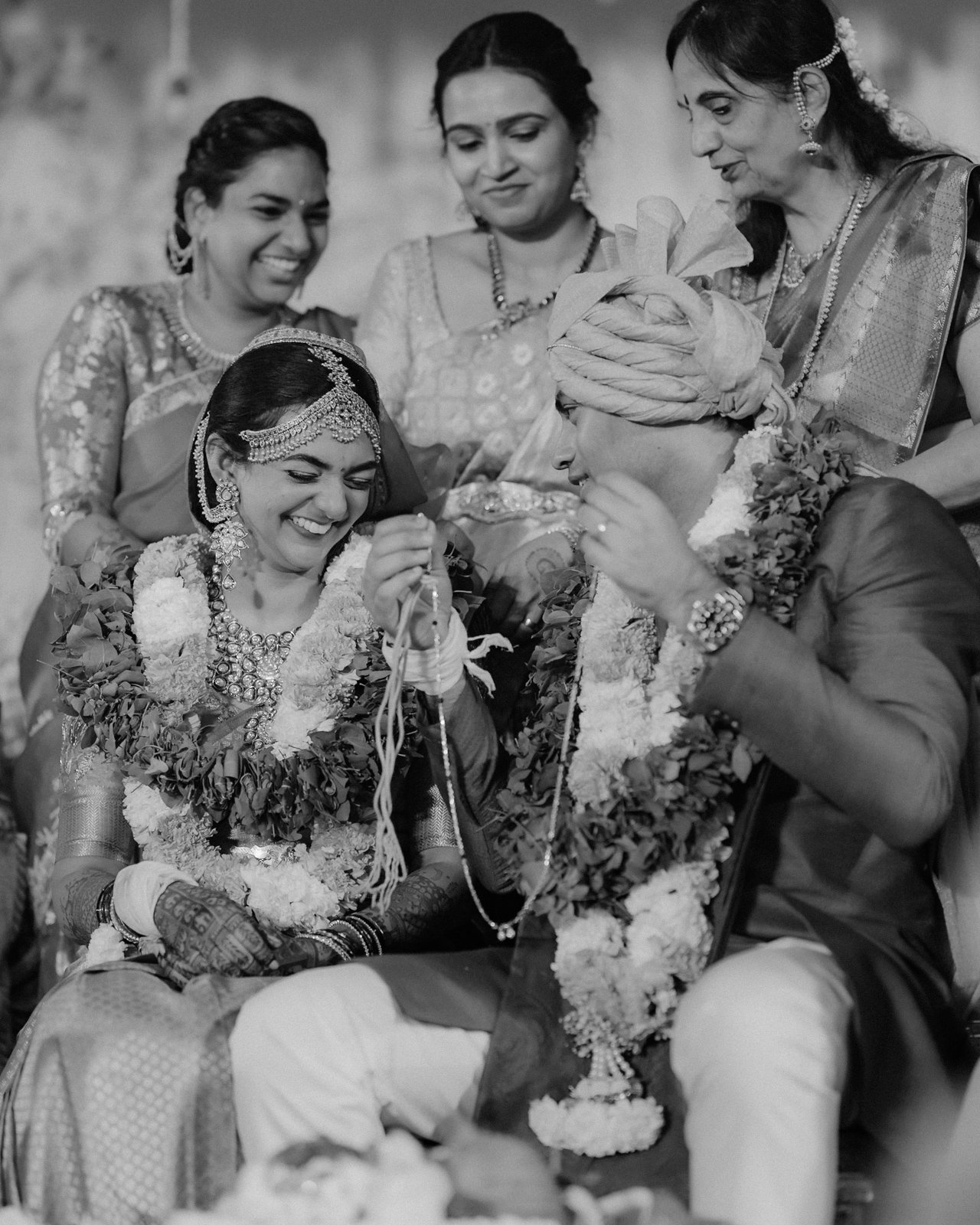 Shrishti laughing with family during the rituals, black and white