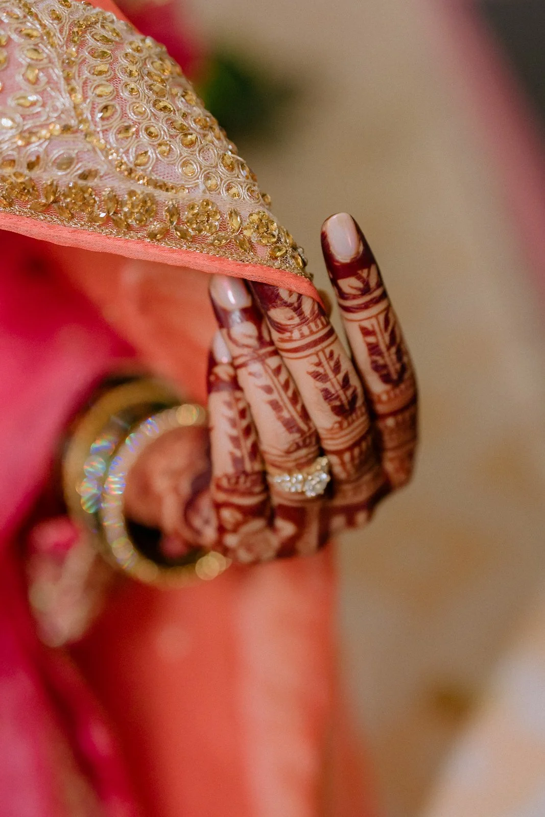 Close-up of Shrishti's hennaed hand and bangles