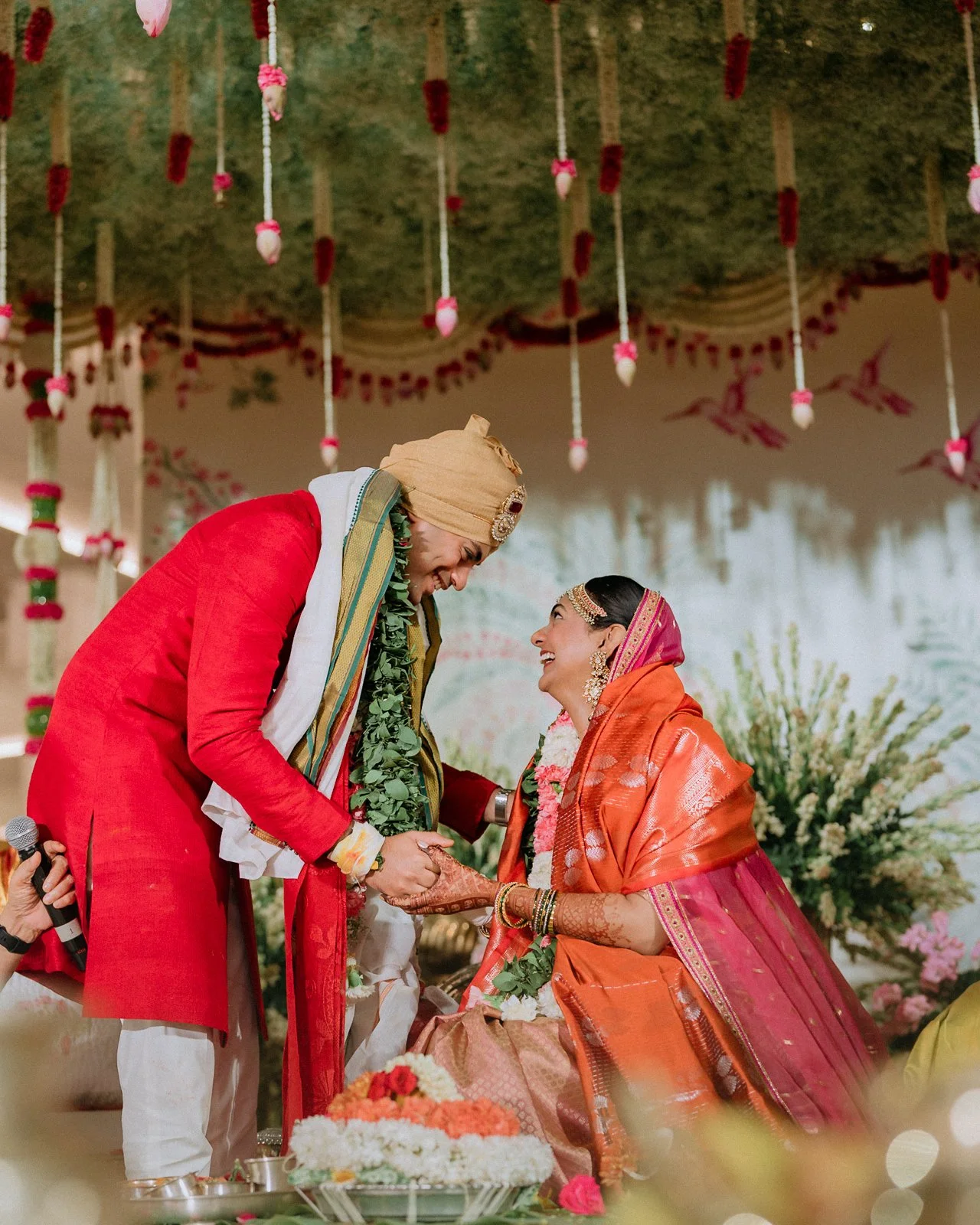 Akhil and Shrishti holding hands at the mandap