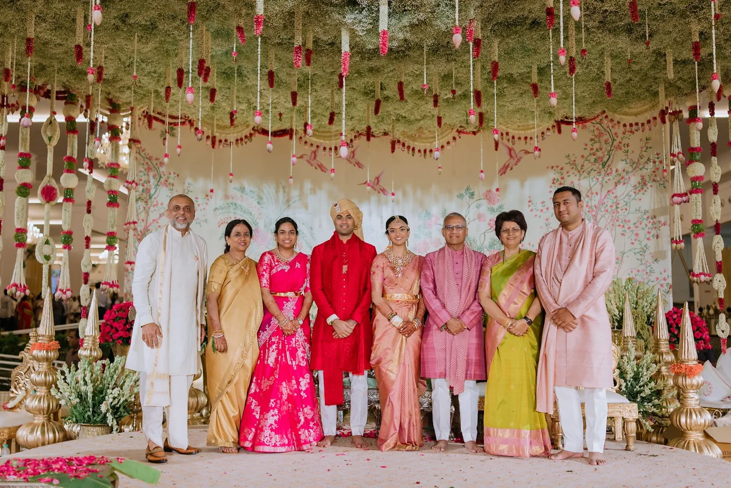 Shrishti and Akhil with both families on the wedding stage