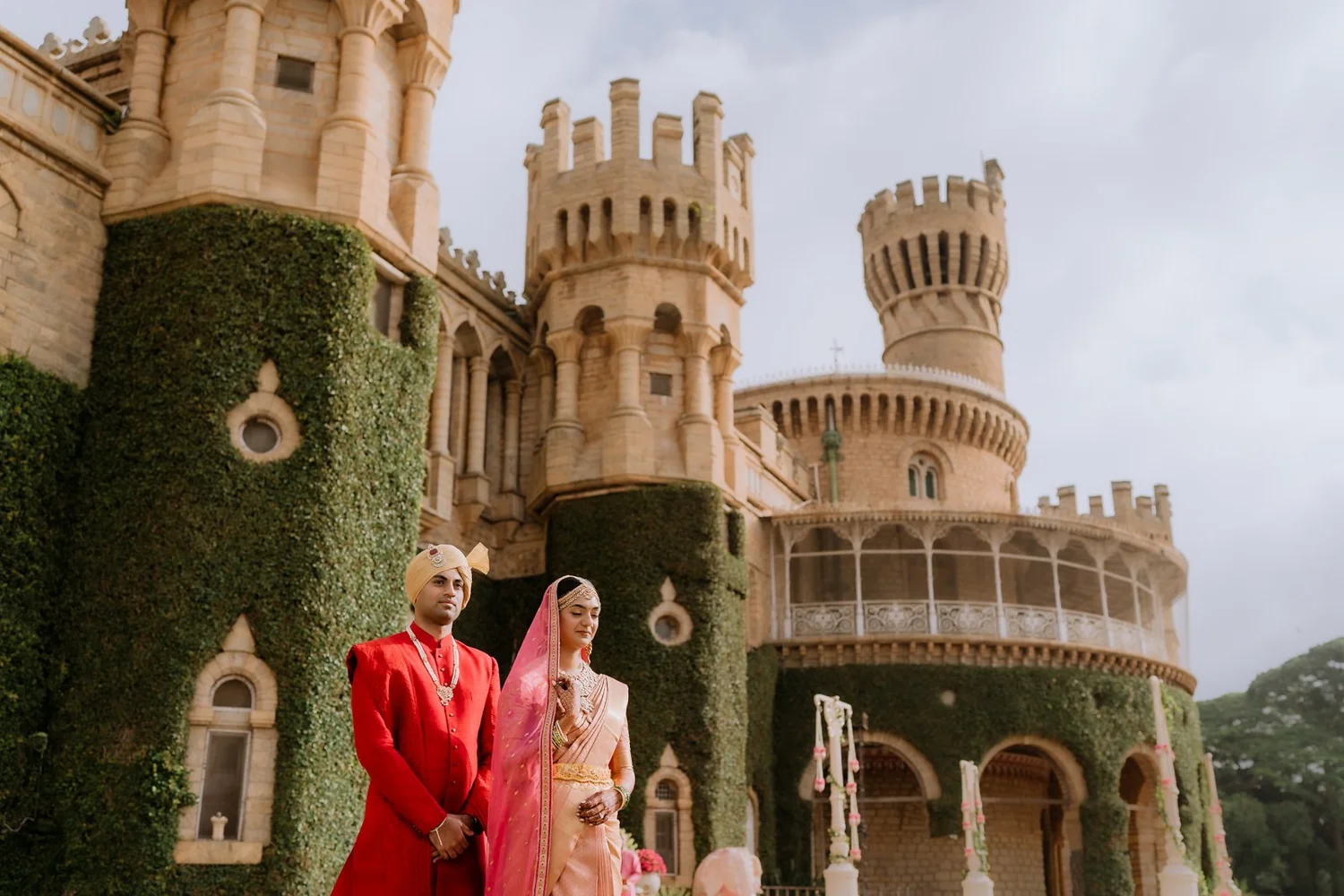 Shrishti and Akhil in front of the turrets of Bangalore Palace