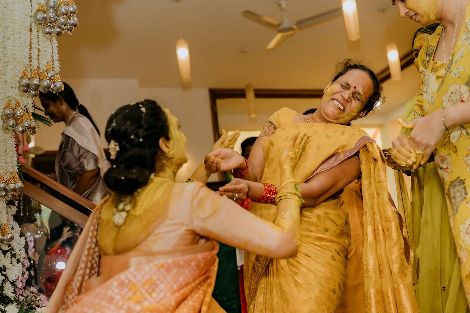 Aunt laughing as the haldi gets playful